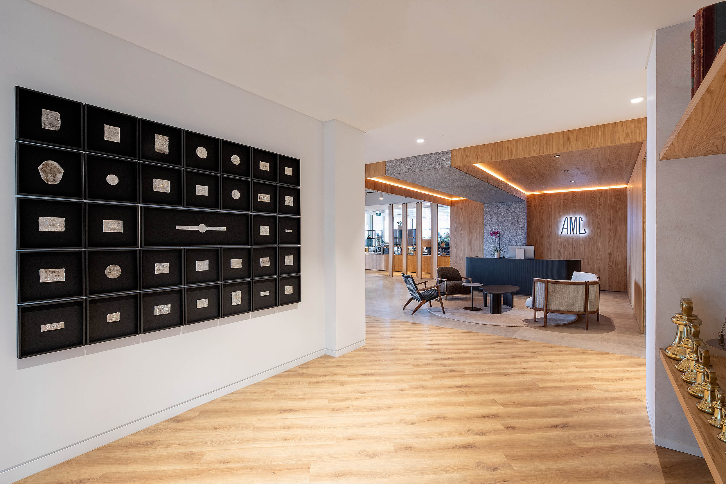 A view of the AMC Group office reception area with contemporary seating and unique wall decor.