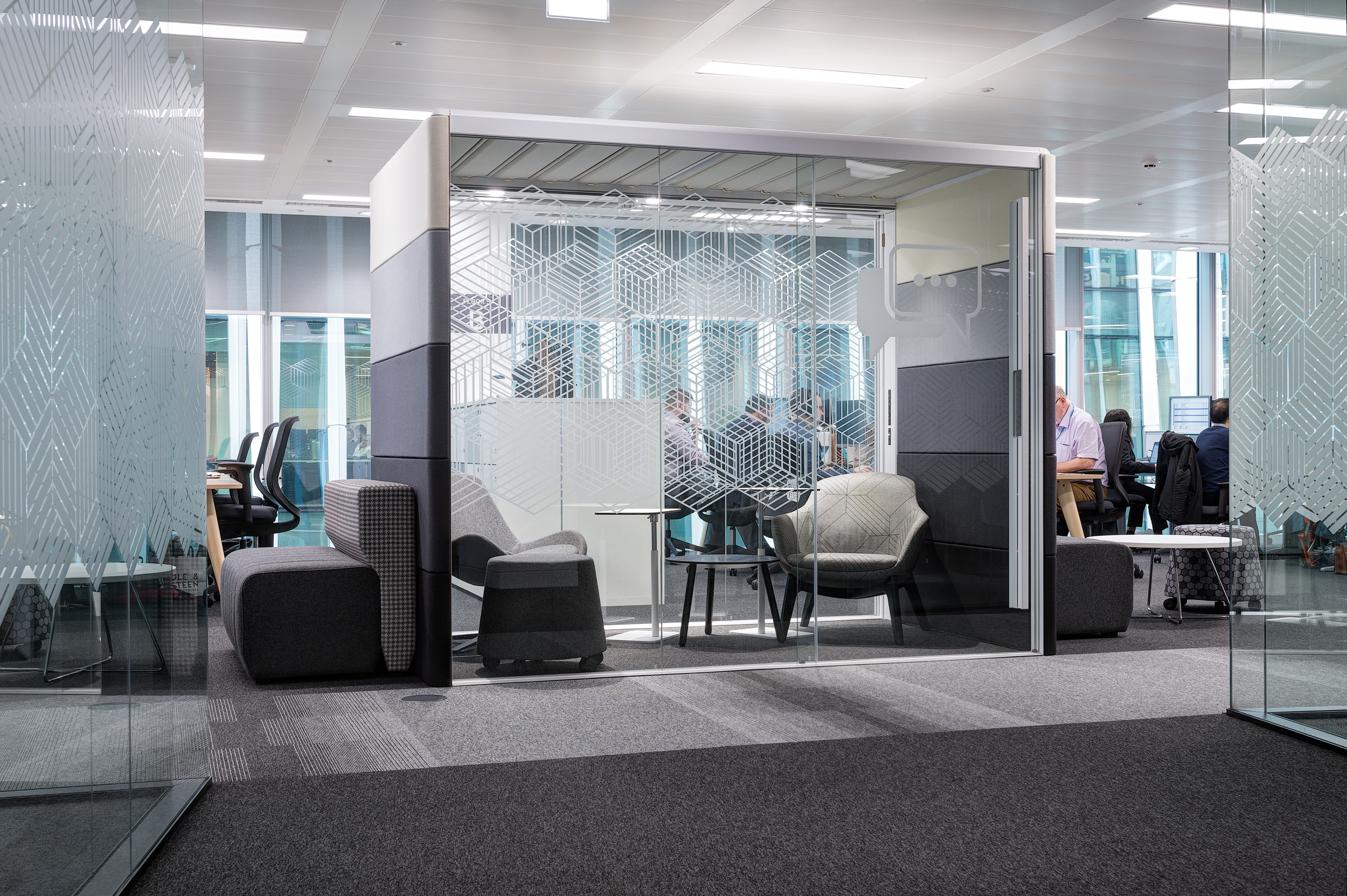 A private meeting room enclosed with manifestations on the glazing at Atkins' Nova North office in Victoria.