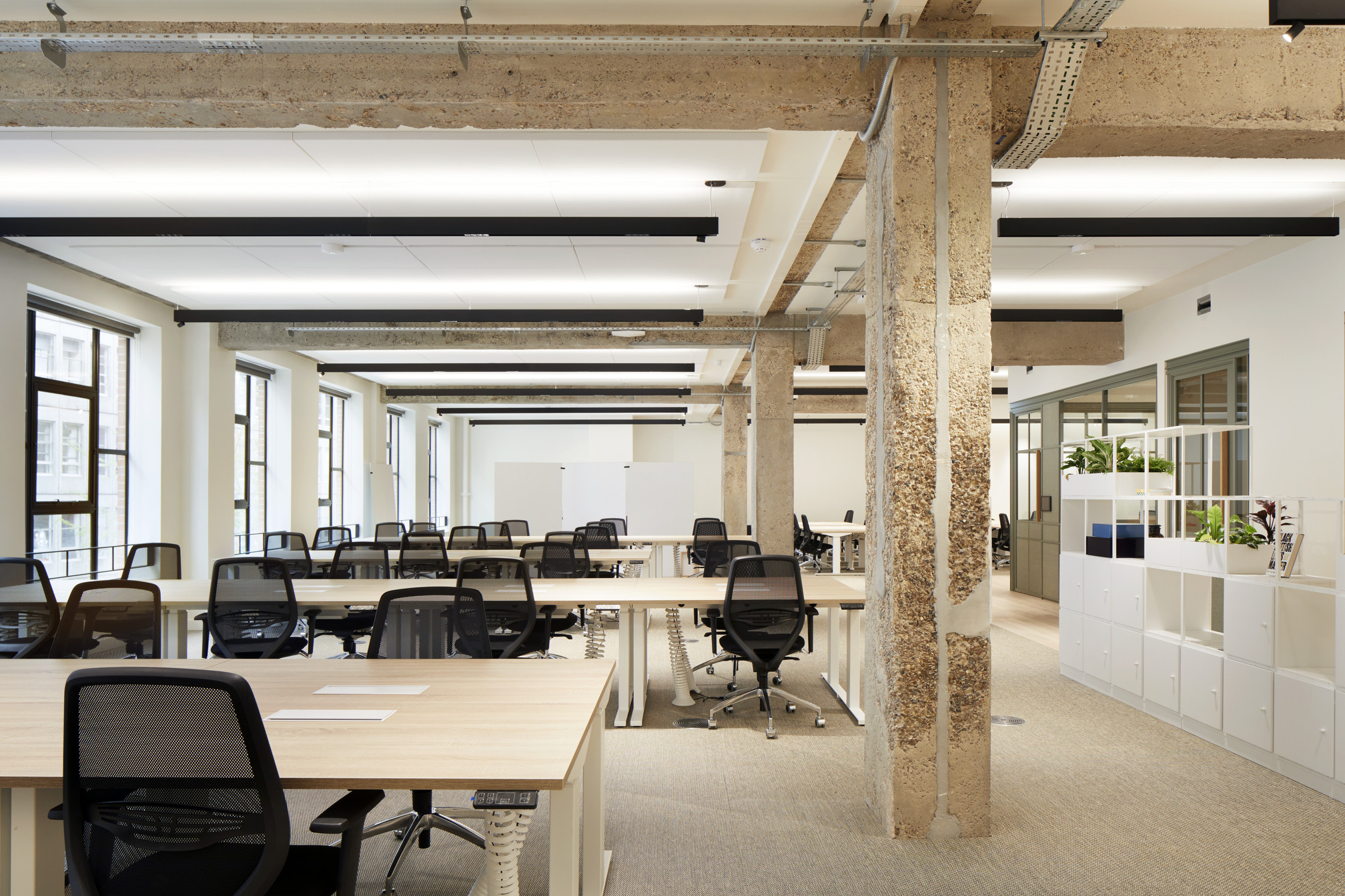 Open-plan co-working office at Fora Greencoat Place, designed by Modus, featuring exposed structural elements, natural light, and ergonomic desks, creating an efficient and comfortable workspace.