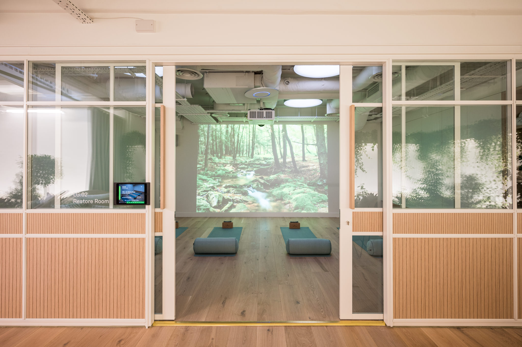 Fora Wells Mews wellness room with yoga mats and a screen projector on the wall.