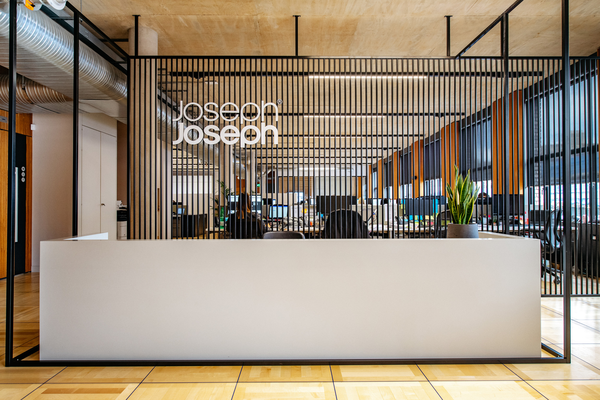 Joseph Joseph white signage behind the white reception.