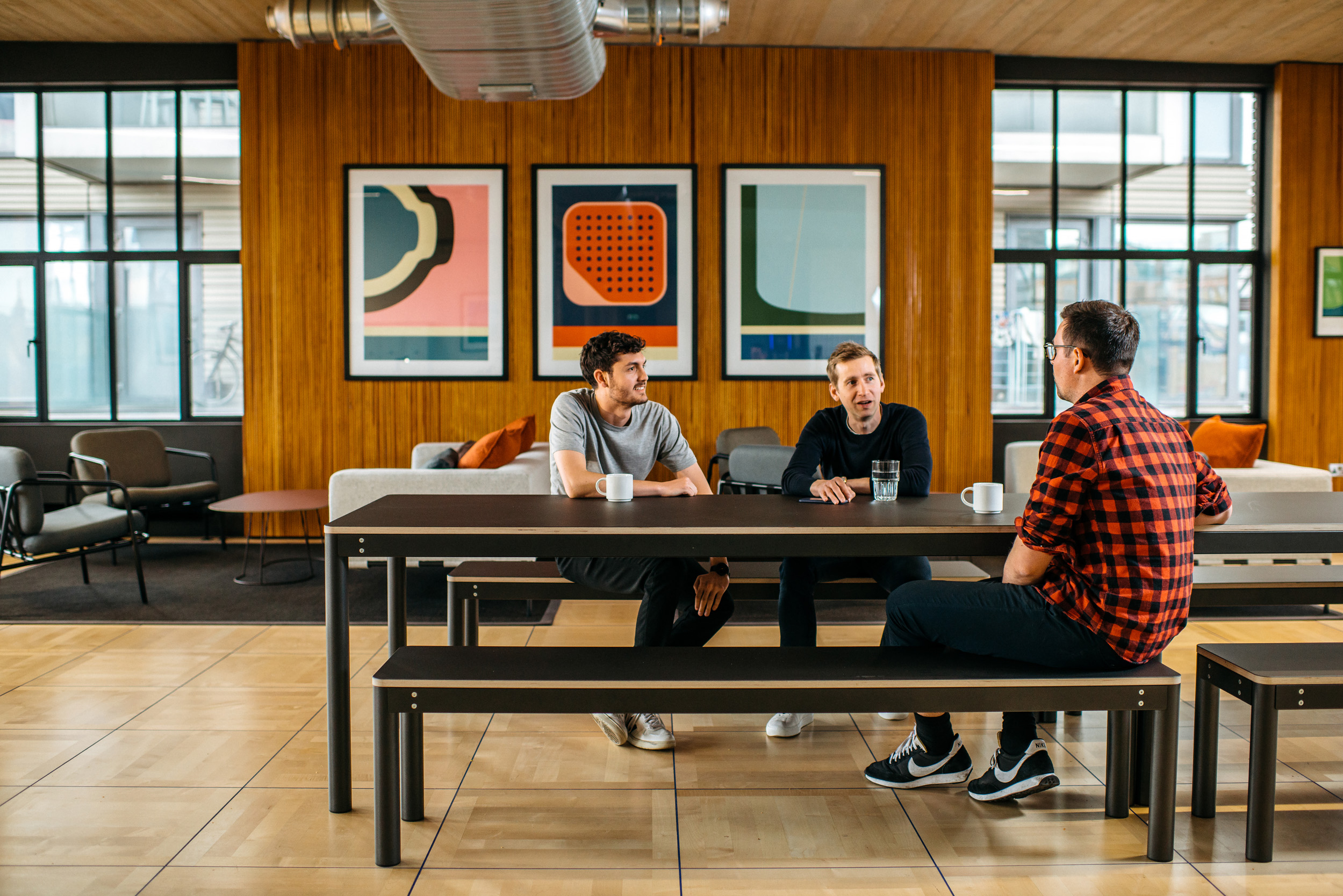 Joseph Joseph open seating area with a black bench, and employees using the space.