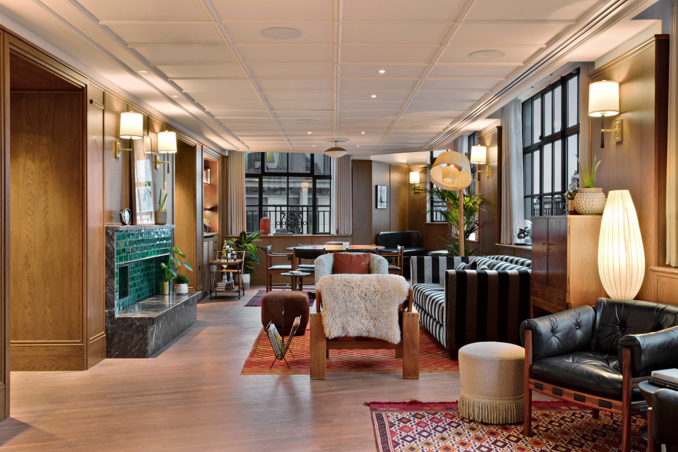 Mortimer House cozy seating area with soft and hard furnishing, eclectic light shades and different geometric patterns.