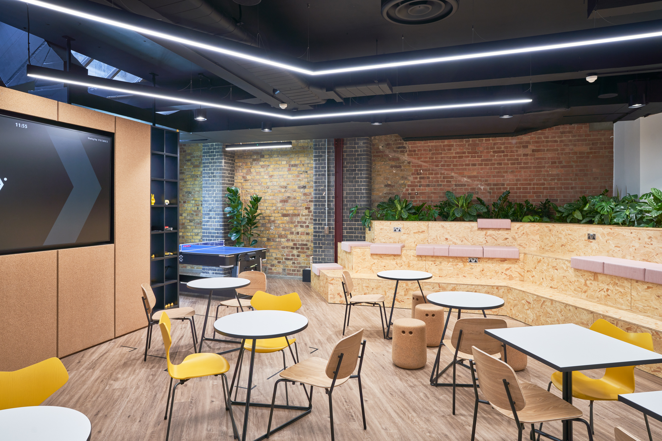 Motorway seating area with an array of seats high and low, following Motorway's branding and colour themes