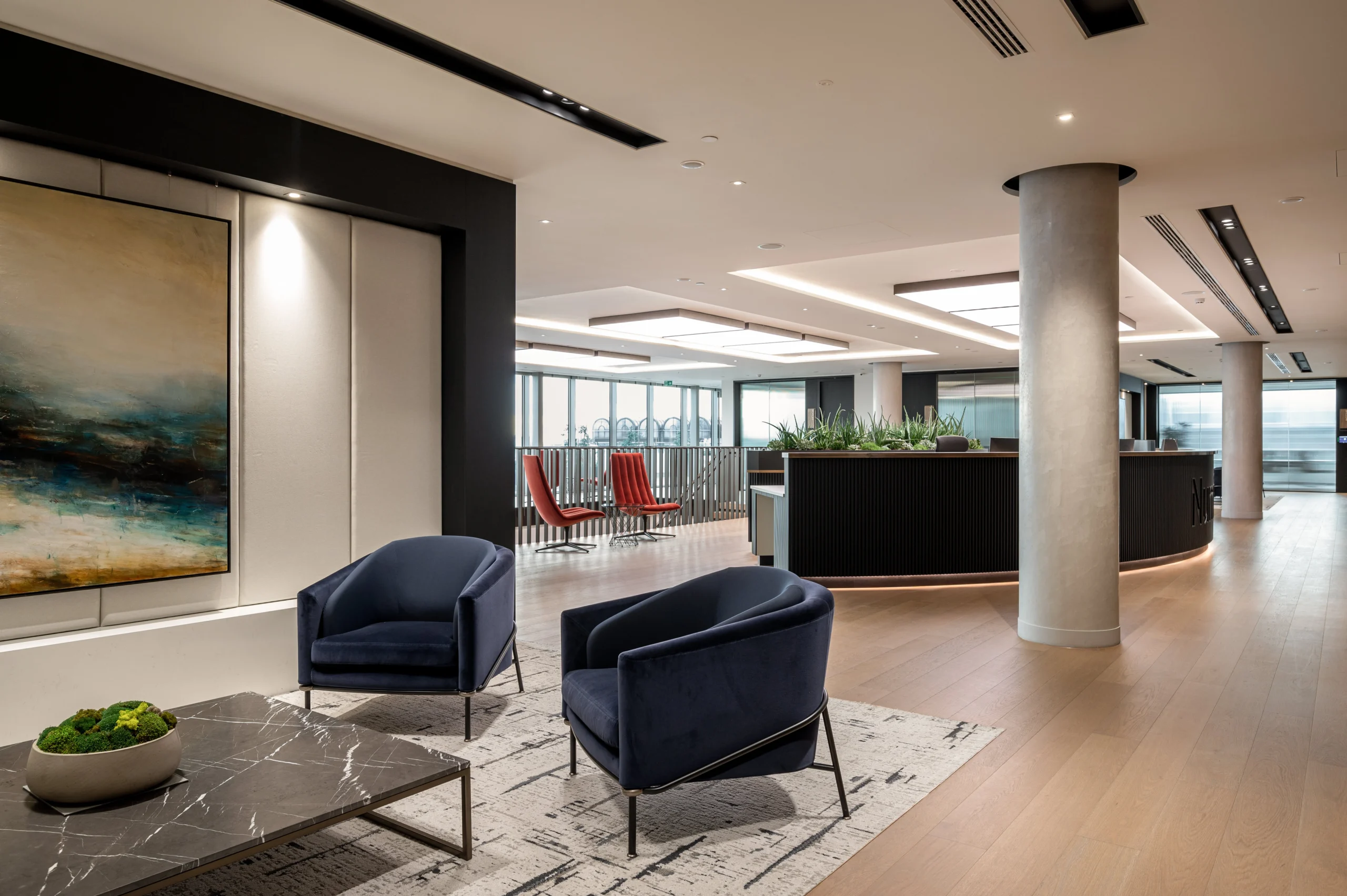 Numis open-plan office with large centralised pillars, acoustic wall panelling and open reception area.