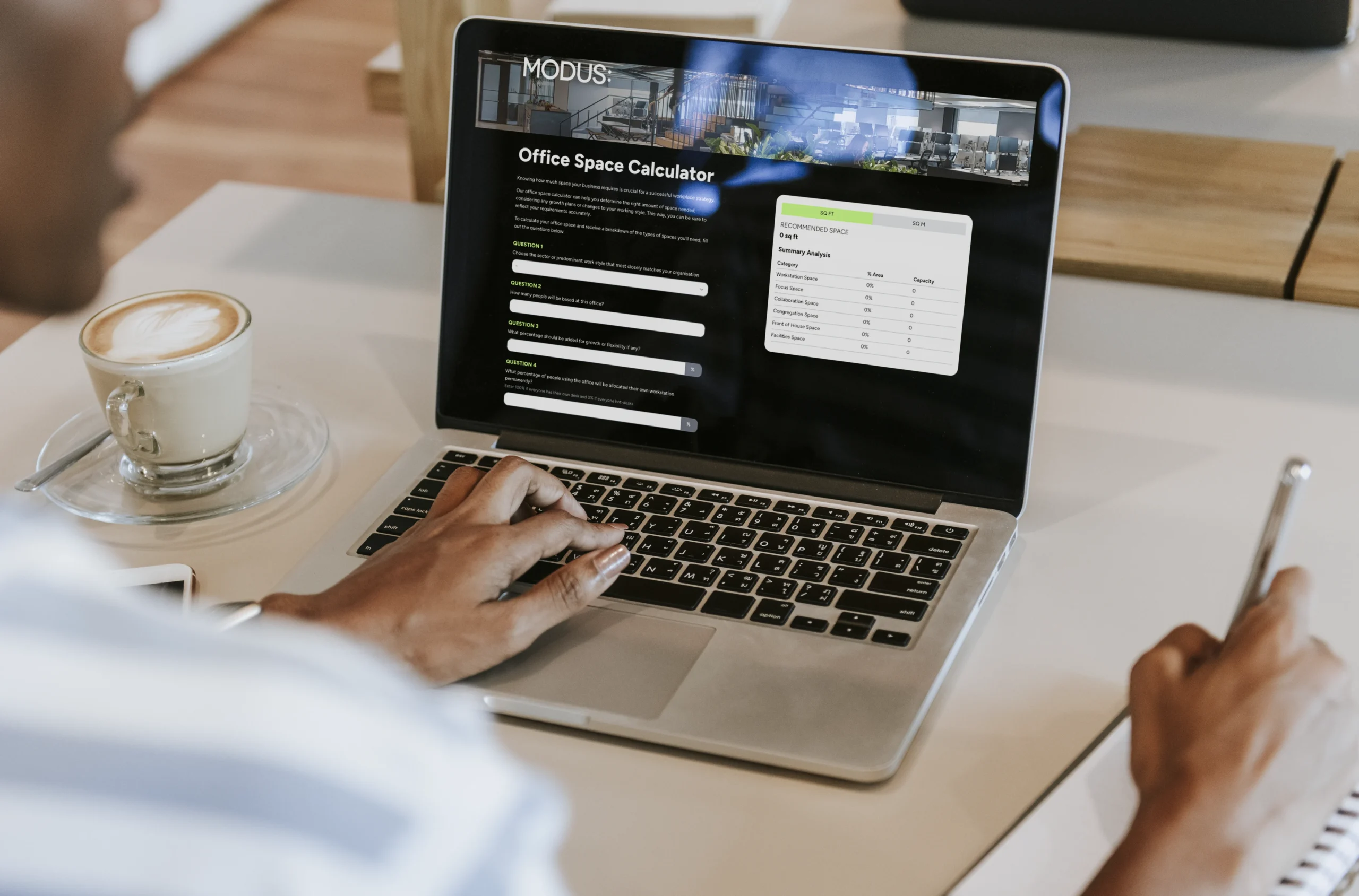 Person using Modus' Office Space Calculator on a laptop, ideal for companies navigating hypergrowth to determine the optimal office space requirements and design solutions.