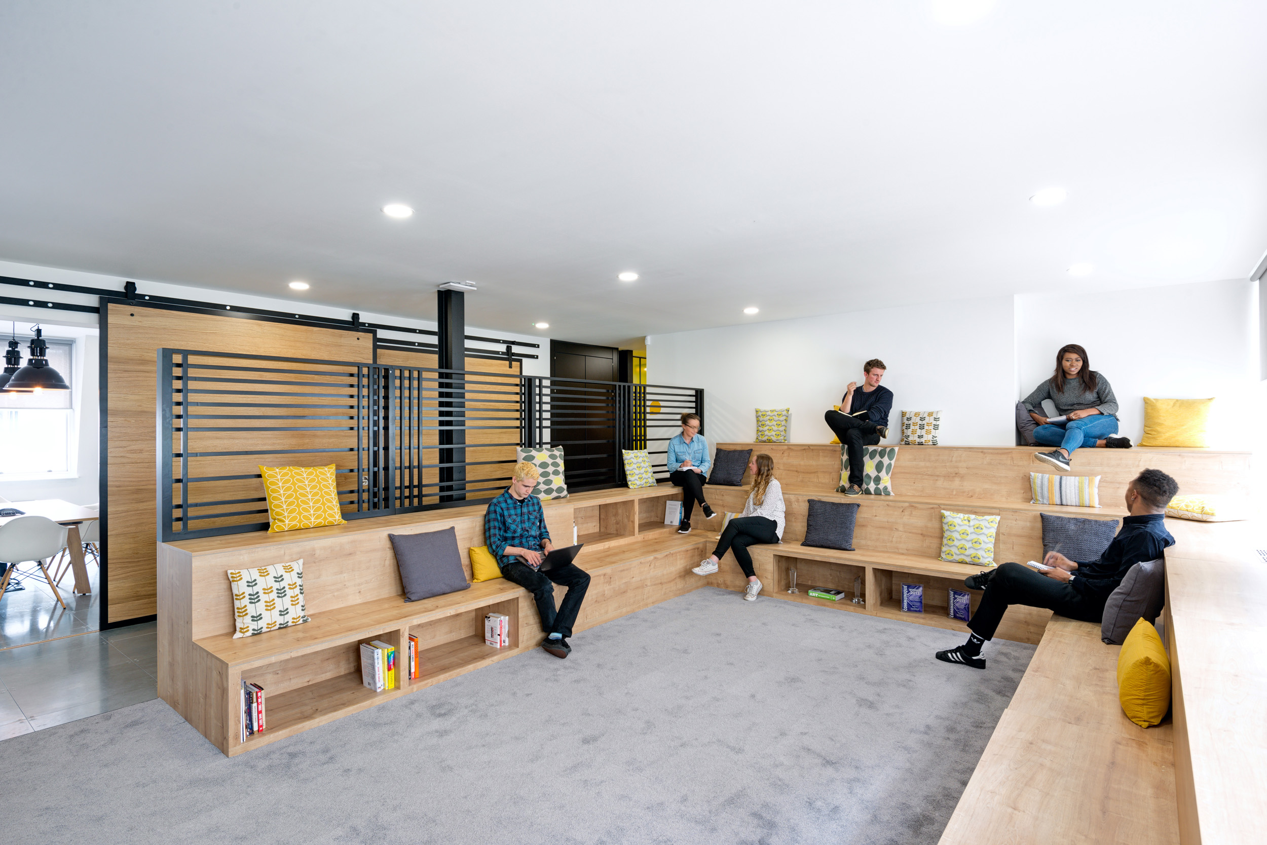 The open seating and work area at Ruderfinn’s office, designed by Modus Workspace, encourages collaboration among team members featuring tiered seating.