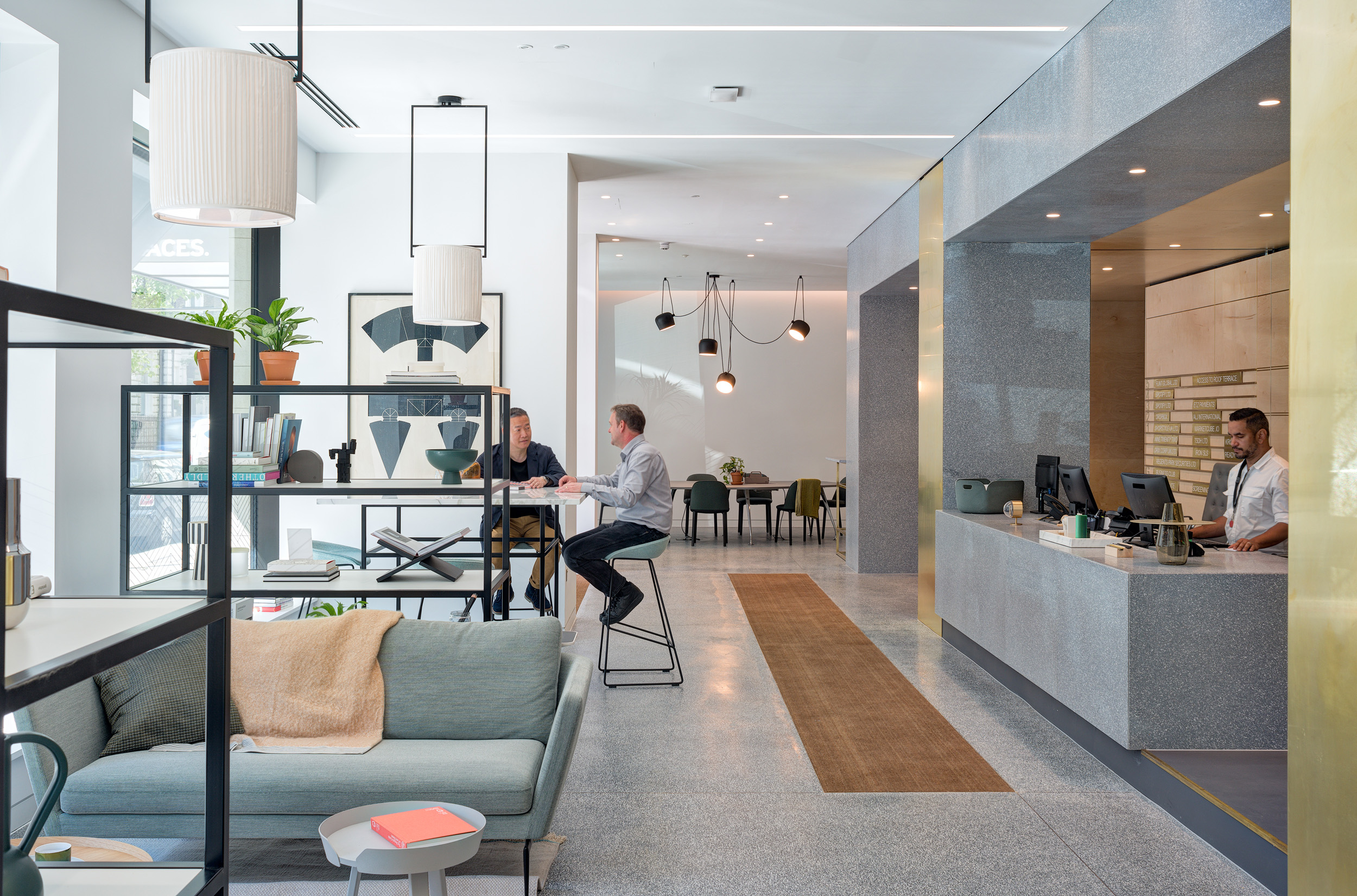 Modern reception and seating area at Spaces Harley Building in Fitzrovia, featuring a sleek front desk and lounge.