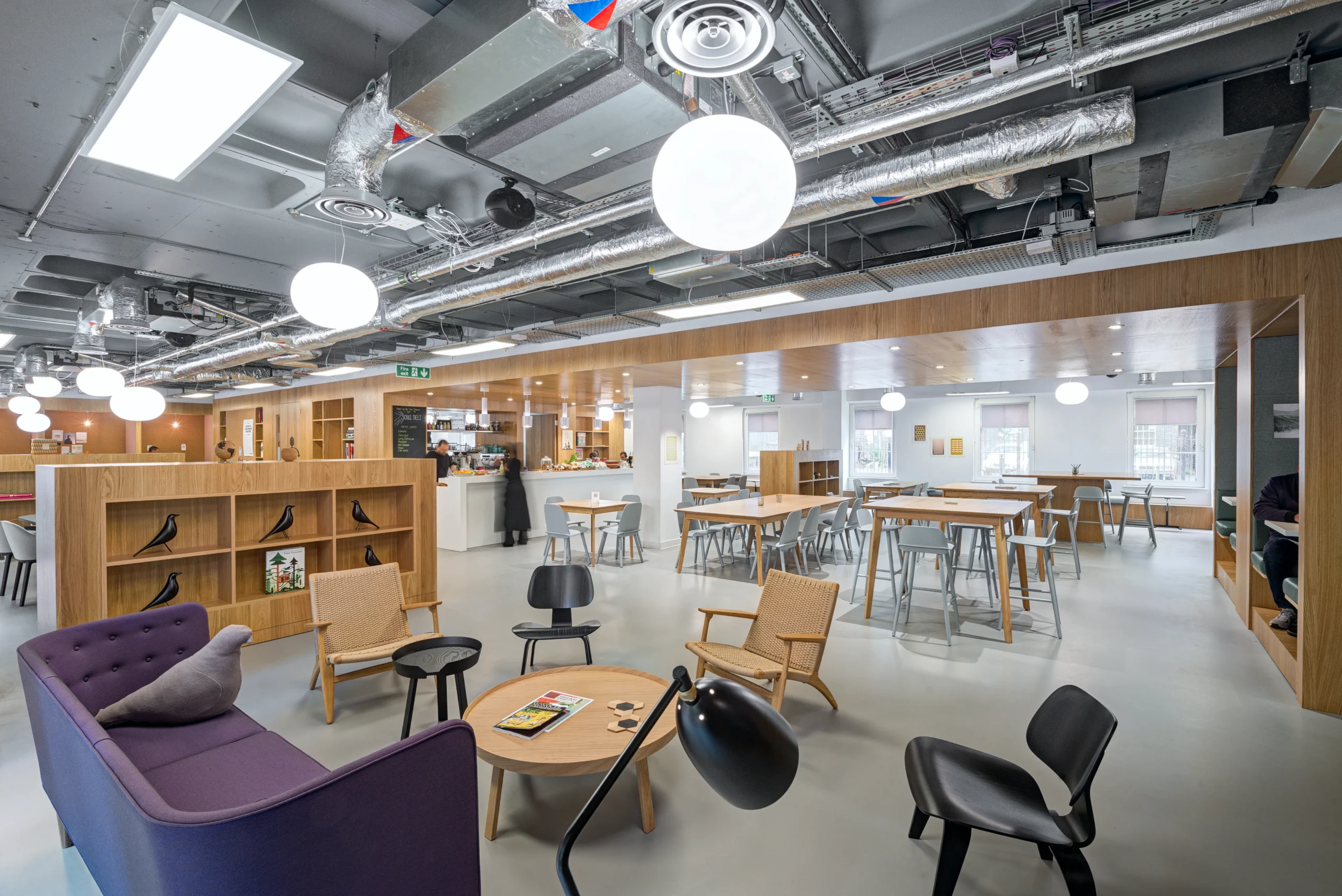 A vibrant and flexible breakout and working space at Spaces Mocatta House in Brighton, with modular seating, light wood finishes, and a relaxed atmosphere for team collaboration.
