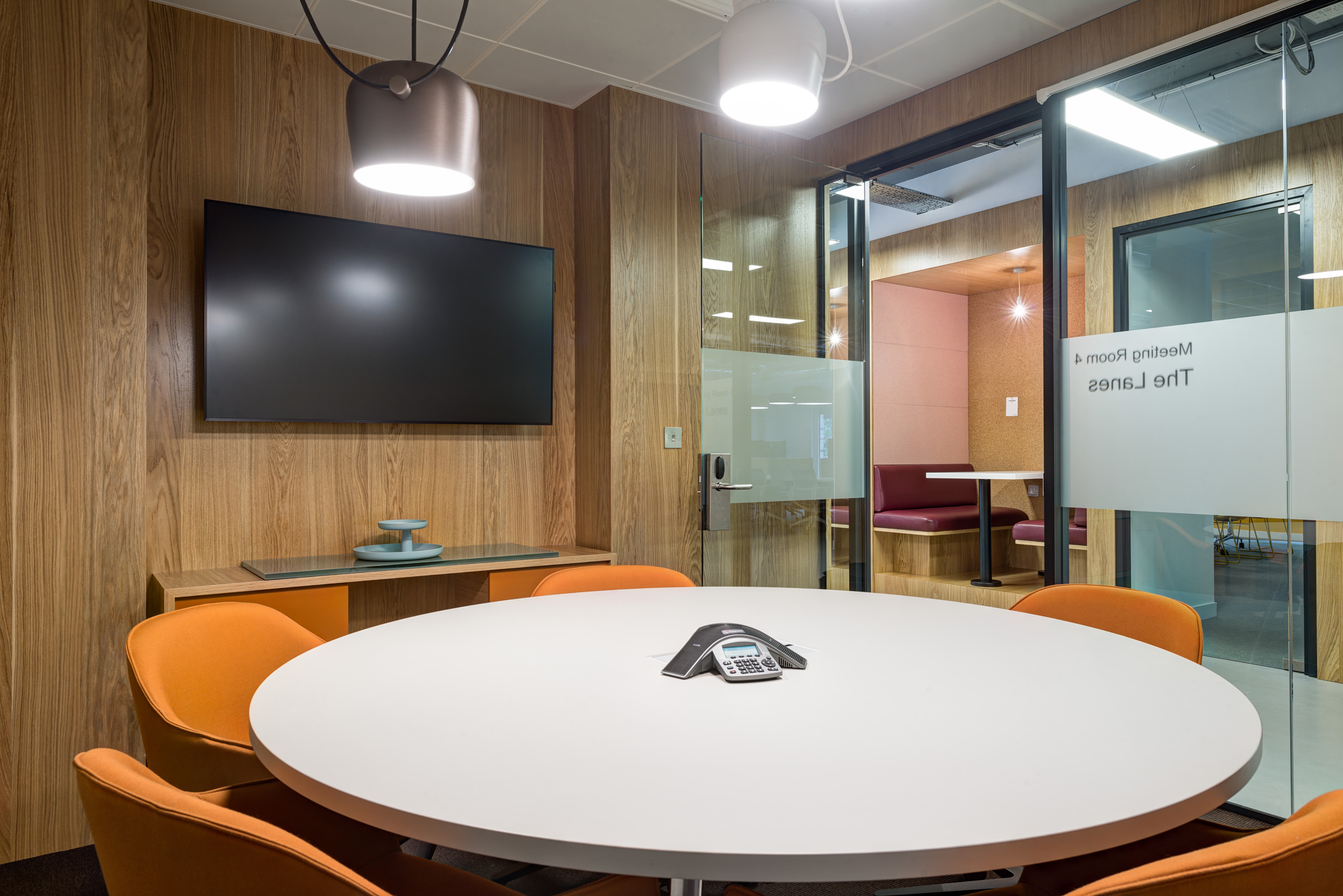 A modern, tech-equipped meeting room at Spaces Mocatta House in Brighton offers comfortable seating and seamless AV integration for professional meetings.