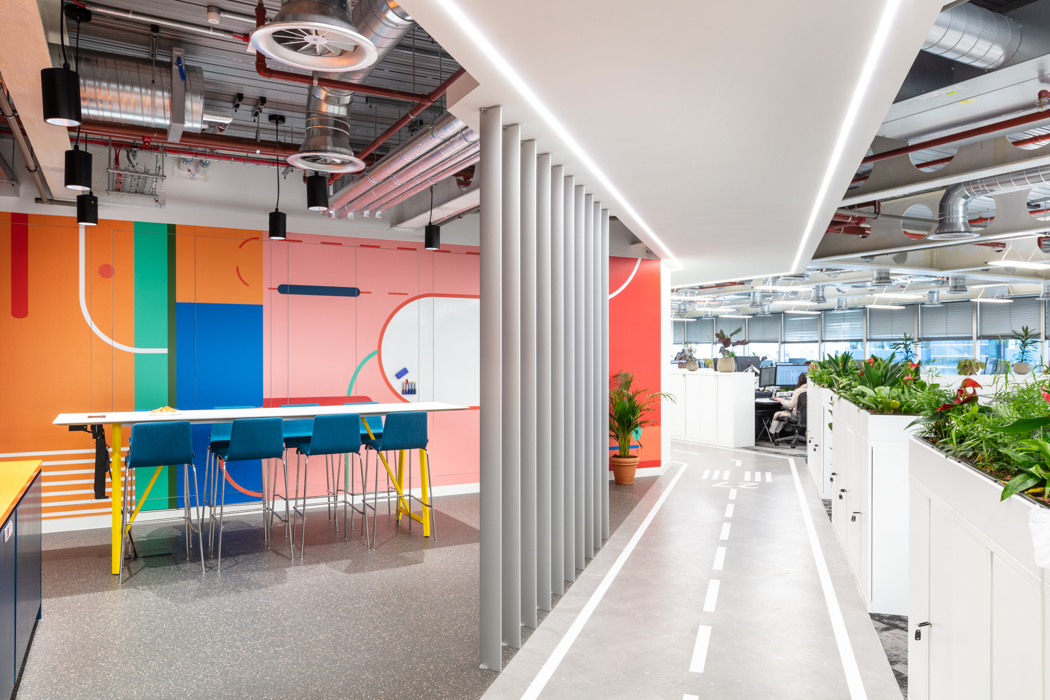 Travelfusion bespoke workspace, with vibrant colours, high spec space and plotted plants.