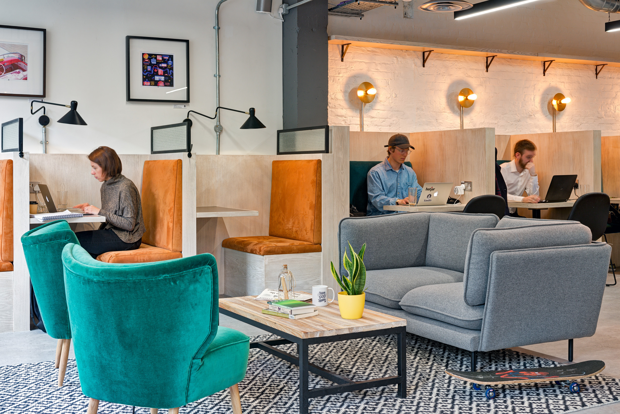 Individual work booths with warm orange seating, providing focused workspaces within Work.Life Bermondsey, designed by Modus Workspace.