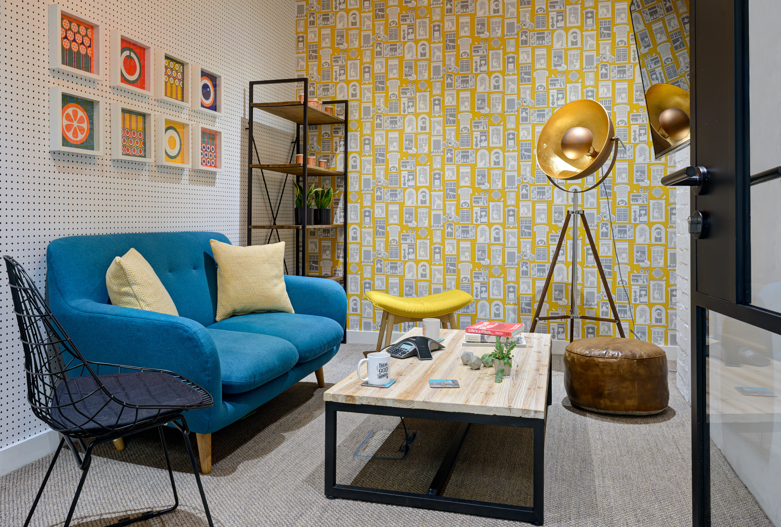 A vibrant lounge featuring blue and yellow furnishings, perfect for casual meetings and relaxation at Work.Life Bermondsey, designed by Modus Workspace.