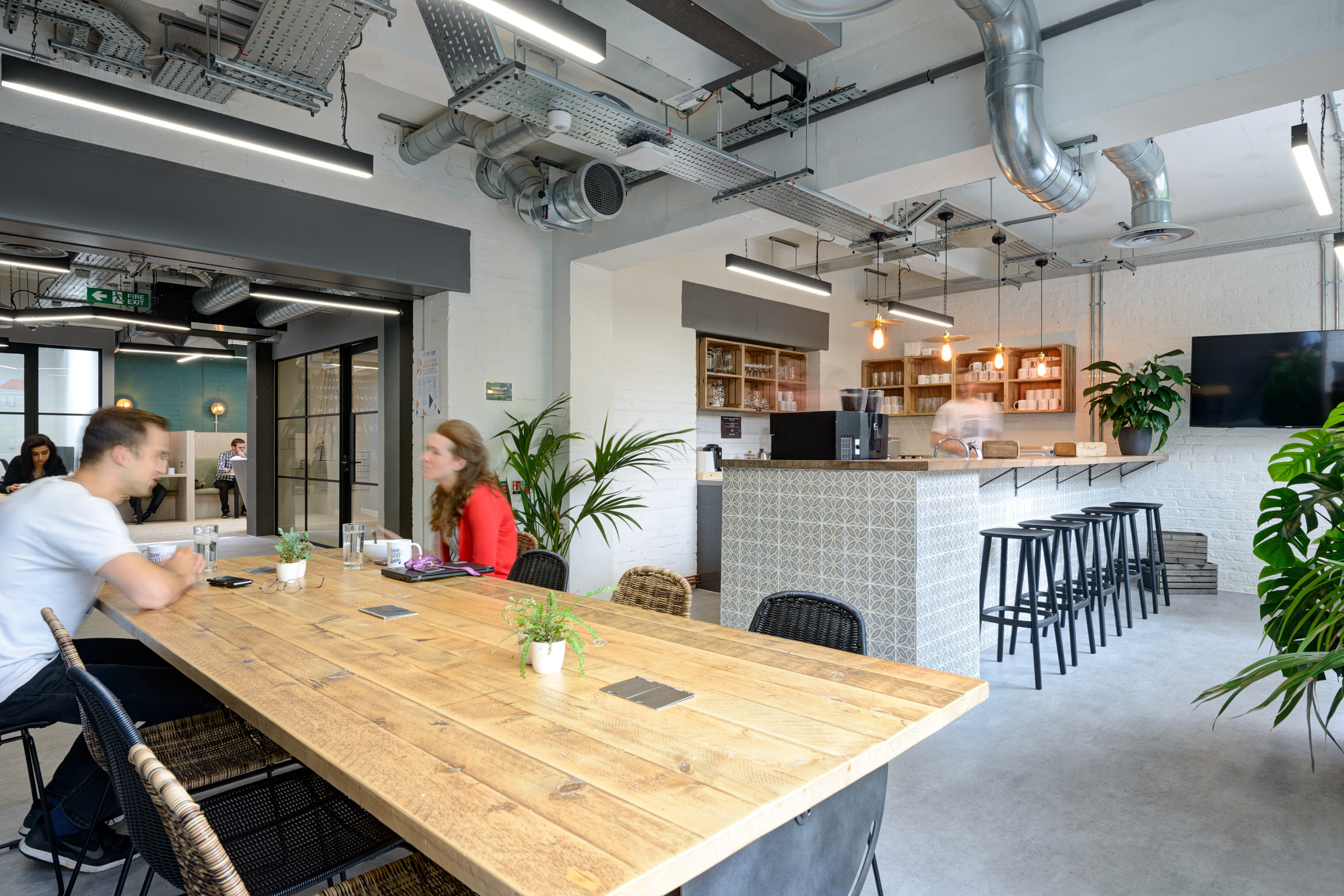 The teapoint area features a rustic wooden table, encouraging collaboration and interaction at Work.Life Bermondsey, designed by Modus Workspace.