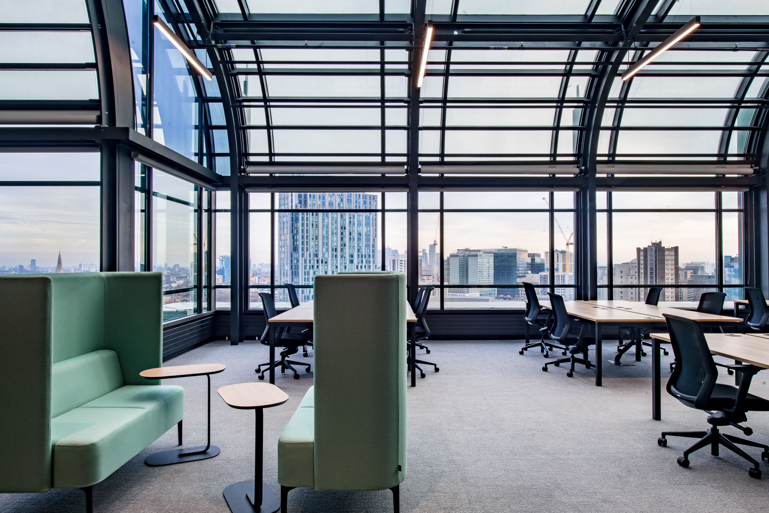 135 Bishopgate open-plan office and bespoke sofa aligned with the brand colours.