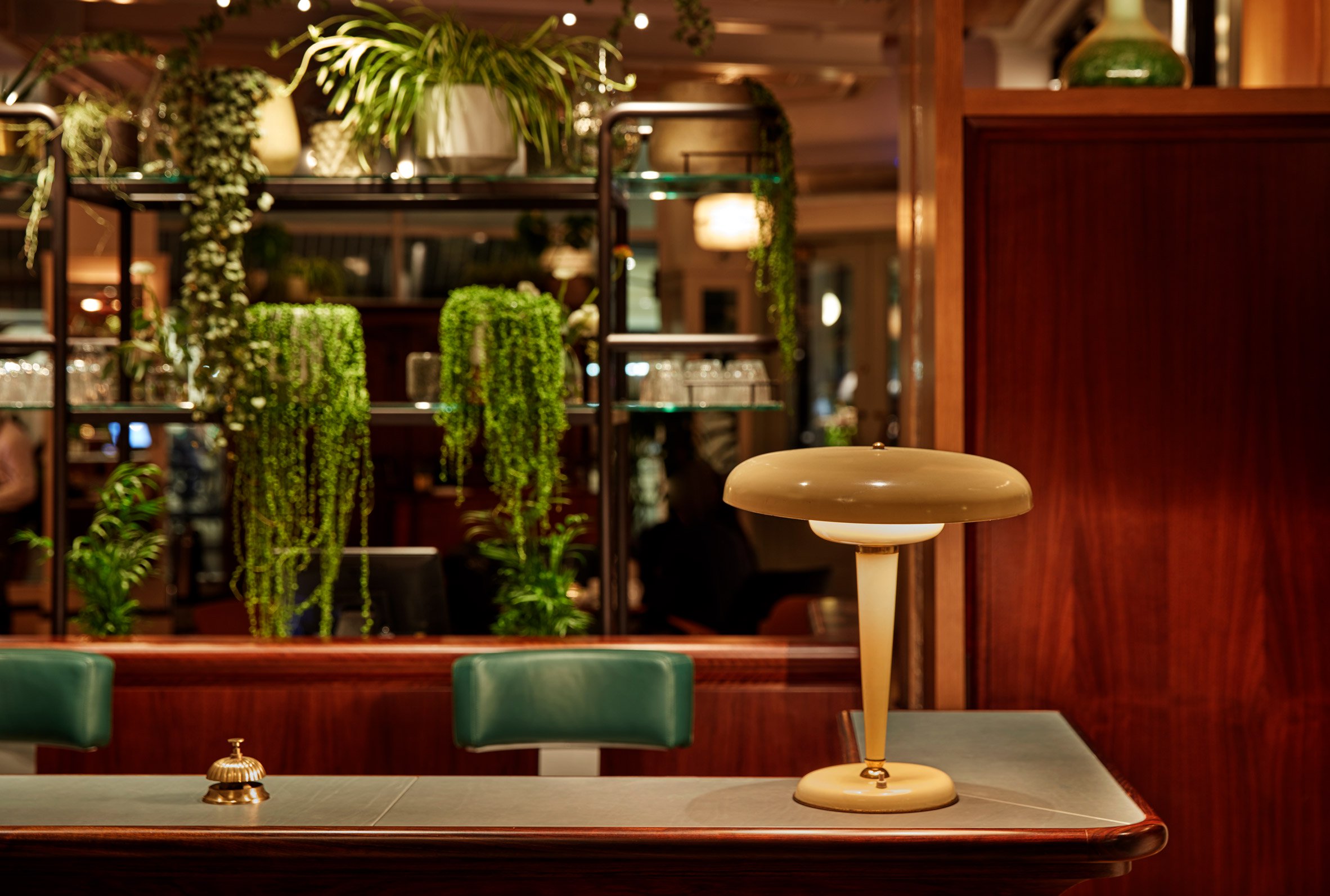 How To Achieve Great Office Design Through Biophilia featuring Mortimer House reception bar, with a bespoke speakeasy atmosphere and biophilic plants.