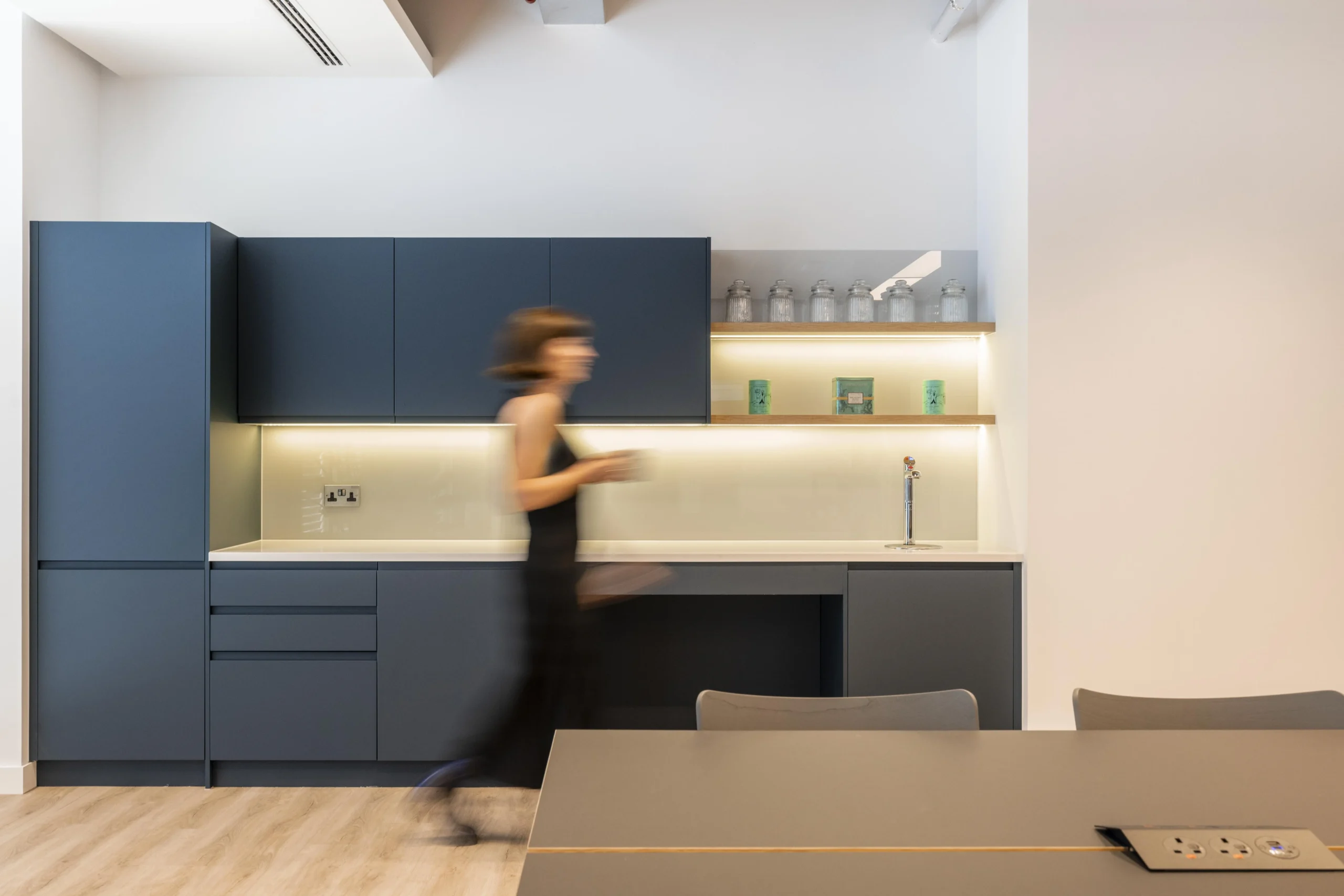 Investment Company teapoint featuring an employee walking past utilising the area.