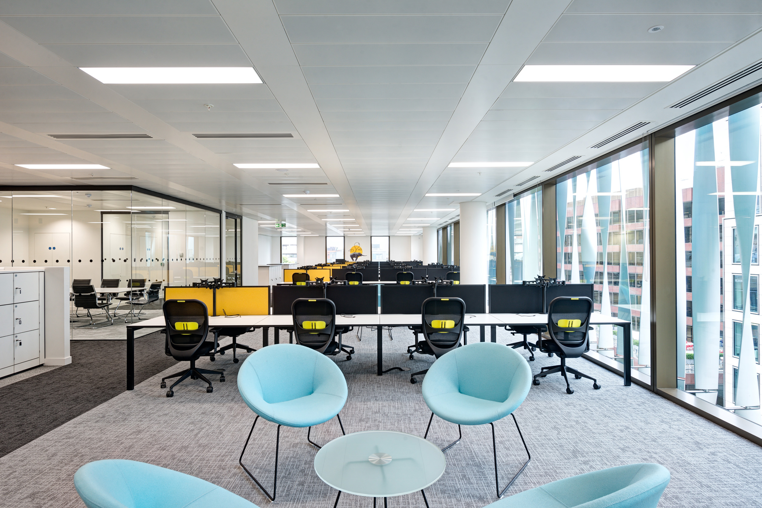 Open-plan workspace at Aldermore Bank, featuring natural light from the floor-to-ceiling glazing and flexible desking areas.