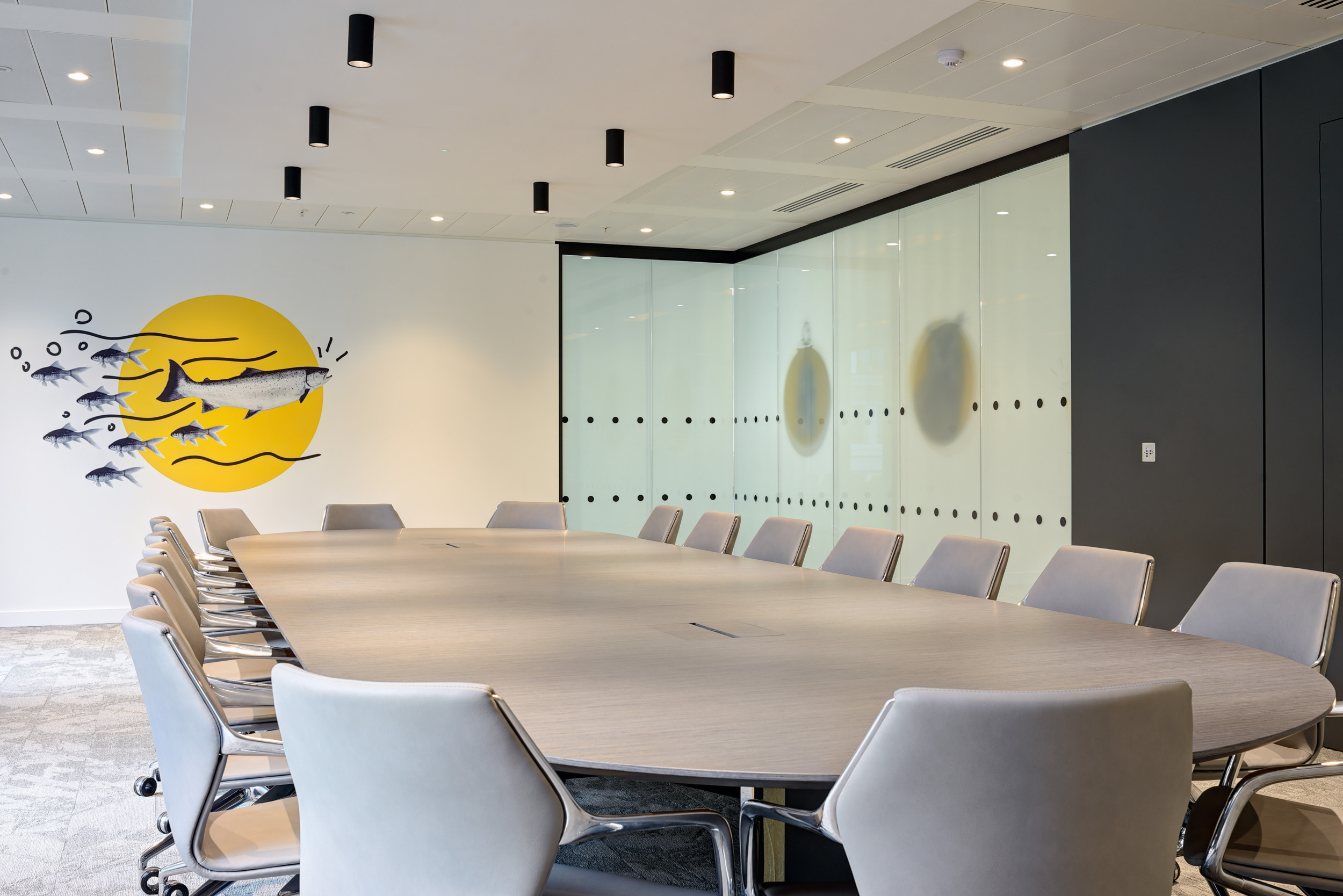 Boardroom at Aldermore Bank’s office, with a large table and custom artwork reflecting the company’s brand identity.