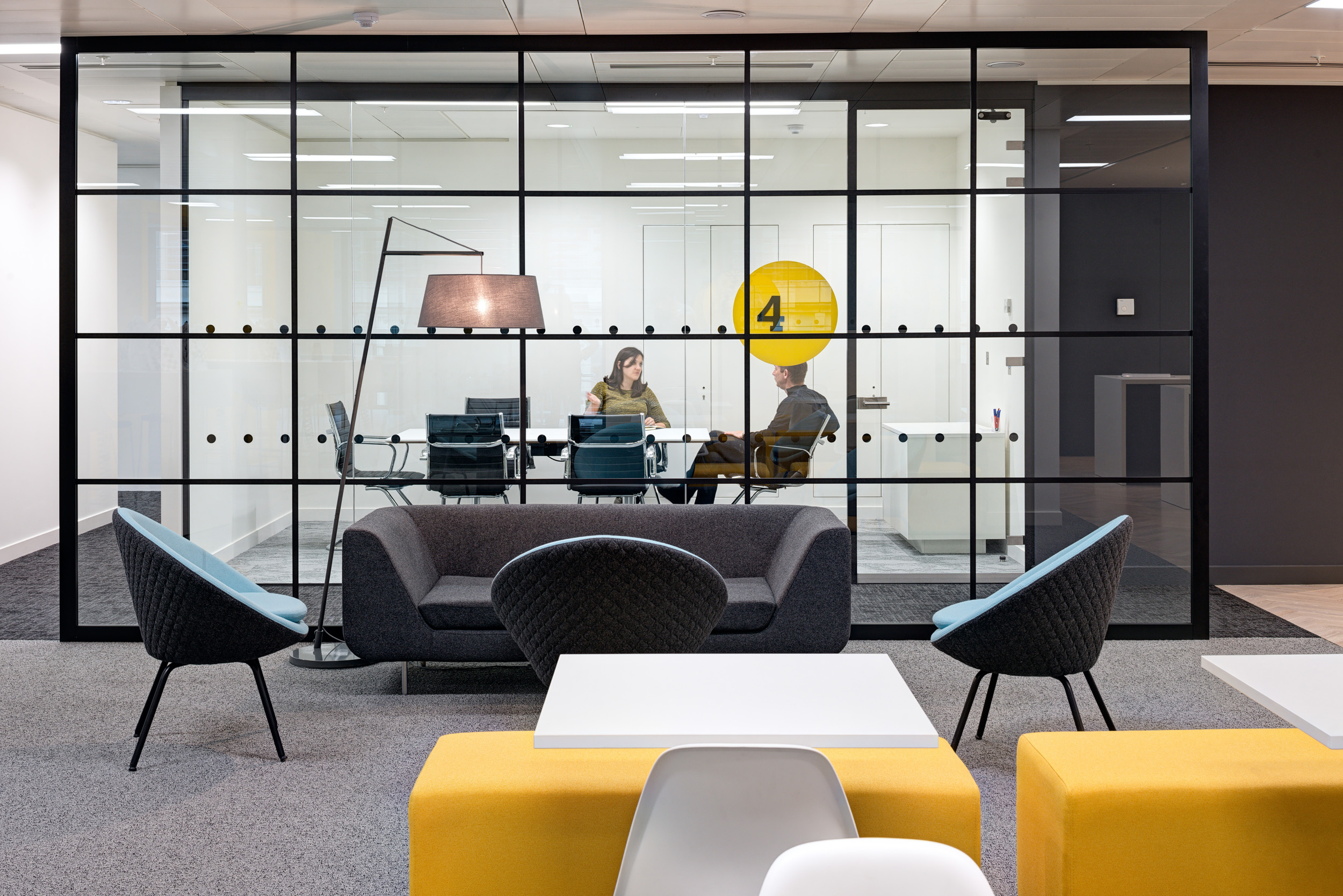 Comfortable breakout area at Aldermore Bank with colourful seating, designed for informal meetings and relaxation.