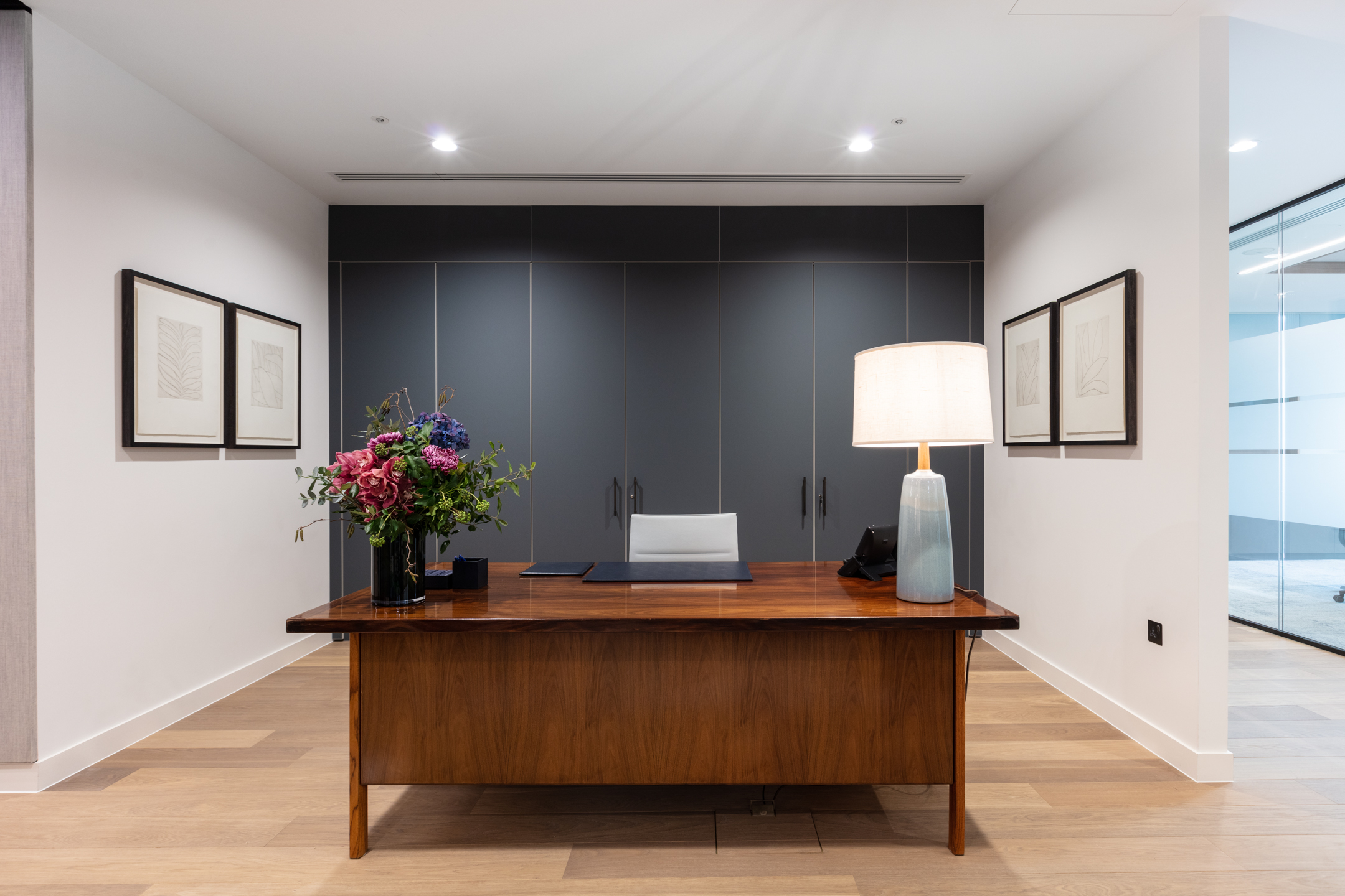 Asset Mangement reception with grey walls, and bespoke lighting