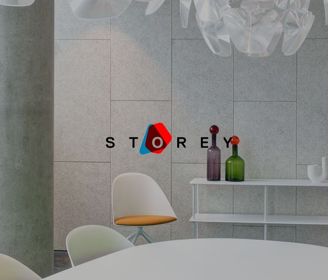 Modern office space at British Land’s Storey featuring minimalist design with sleek furniture, decorative bottles, and a contemporary light fixture