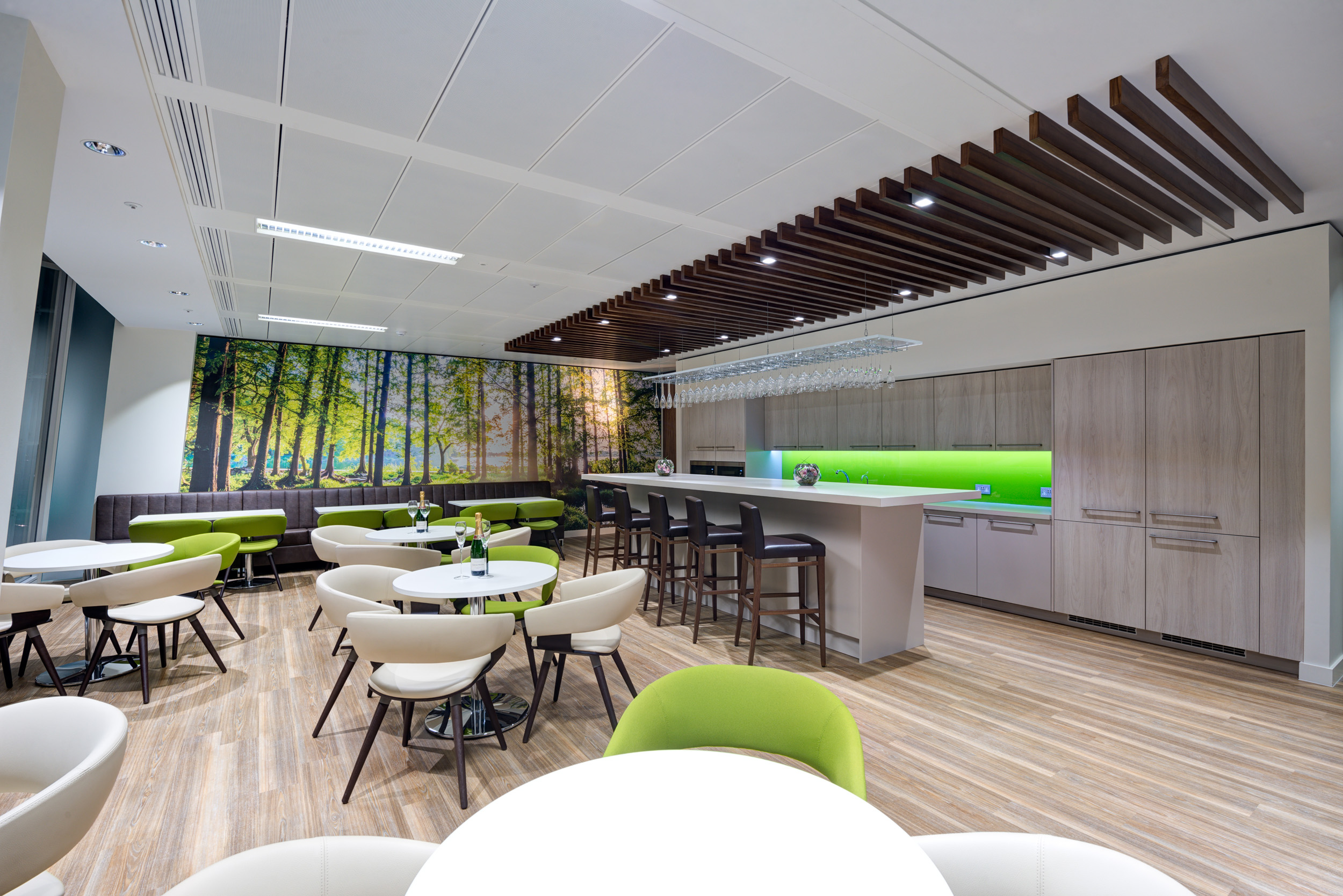 A contemporary teapoint and dining area within Foresight Group's office at The Shard, furnished with green accents and designed for both casual meetings and relaxation.