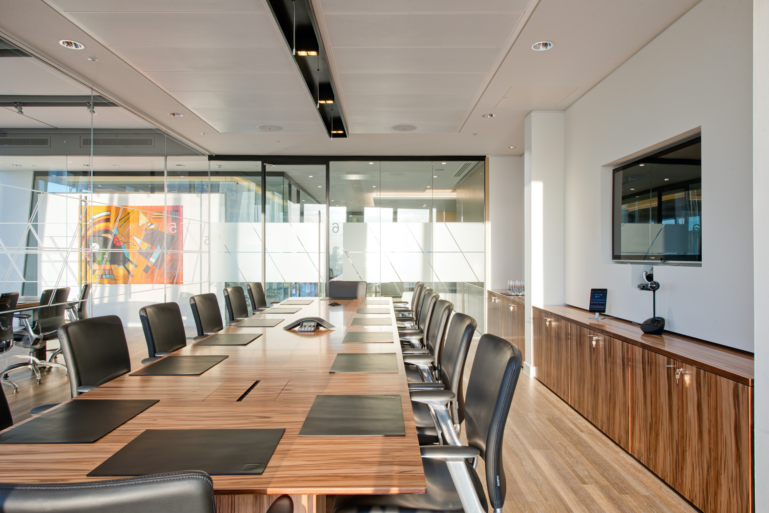 Foresight Group’s boardroom in The Shard, featuring a long wooden conference table, ergonomic leather chairs, and glass walls offering natural light and views of London.