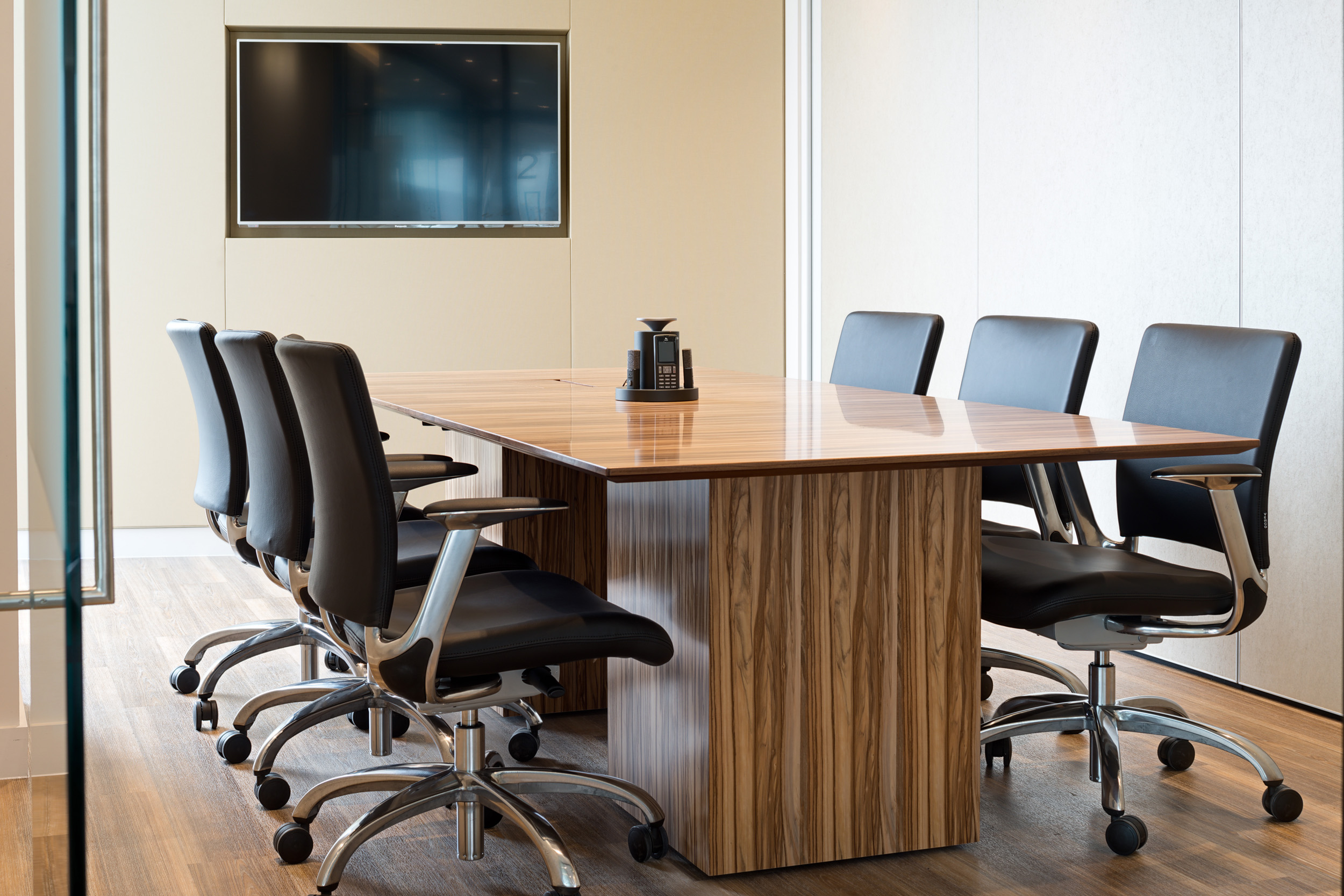 A private meeting room at Foresight Group's office in The Shard, featuring a minimalist wooden table and comfortable office chairs in a professional setting.