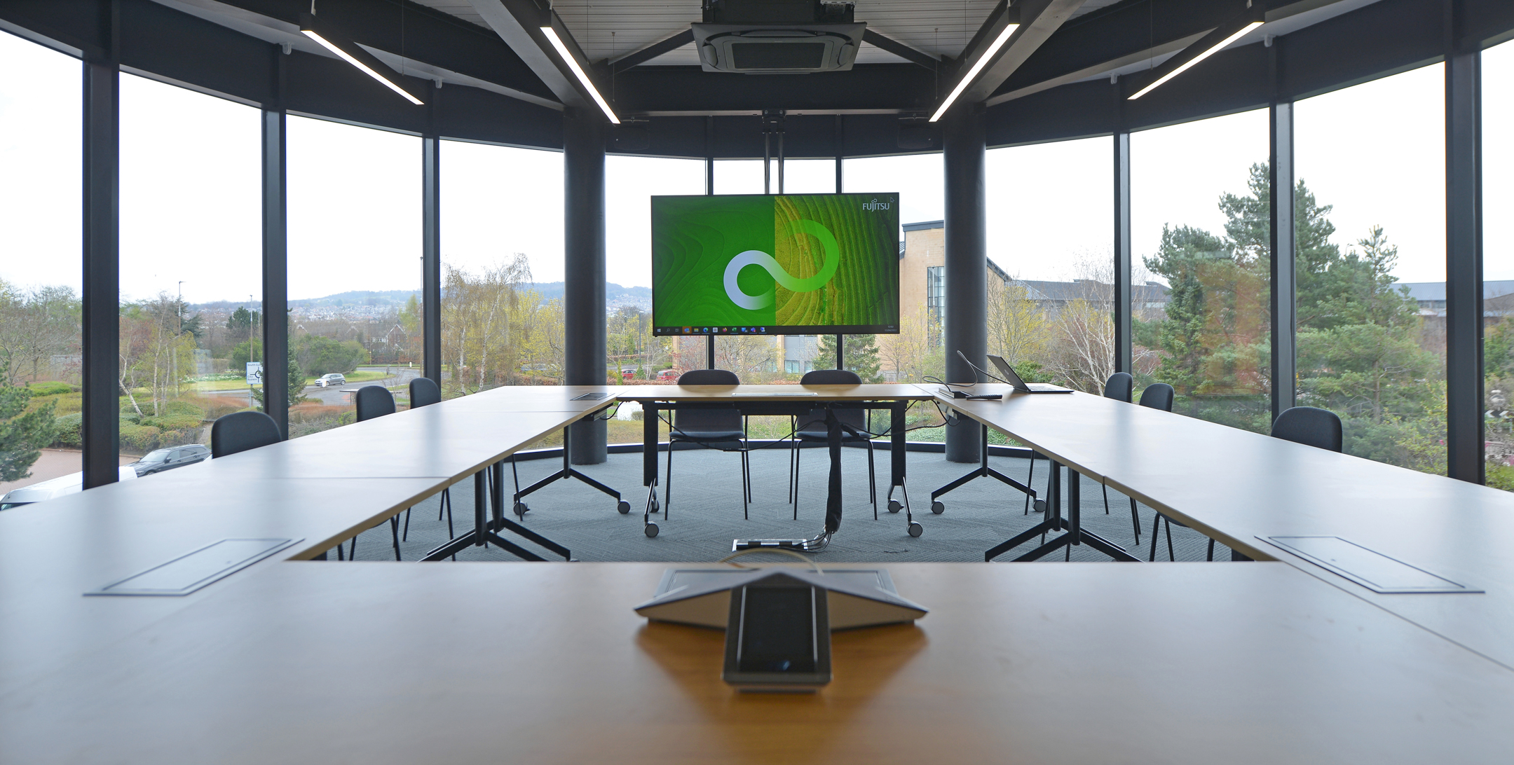 Boardroom at Fujitsu Services Edinburgh with panoramic windows and state-of-the-art technology. Designed by Modus Workspace to provide a professional setting with inspiring views.