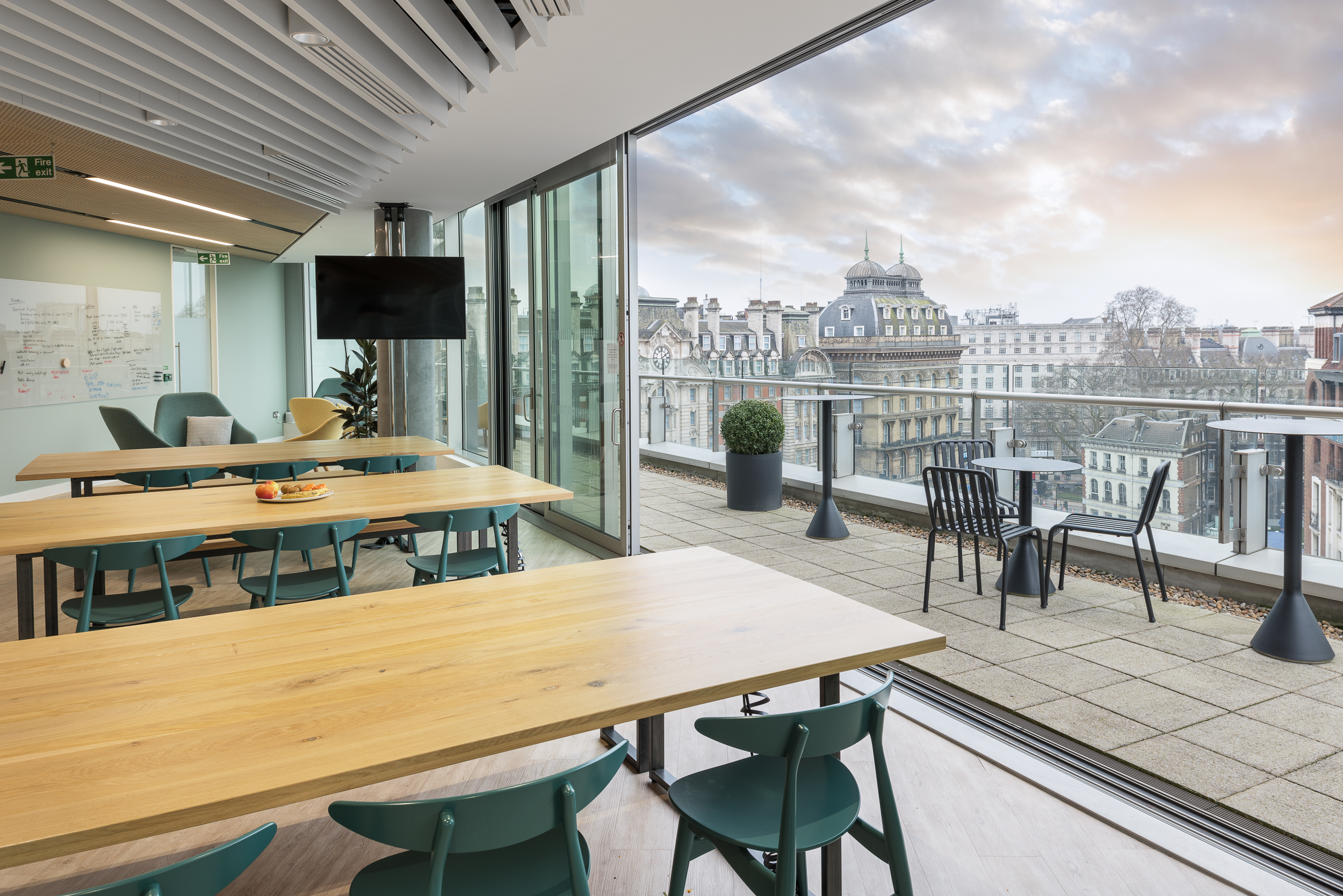 GIP's breakout area with floor-to-ceiling windows and outdoor terrace access, offering stunning views of London.