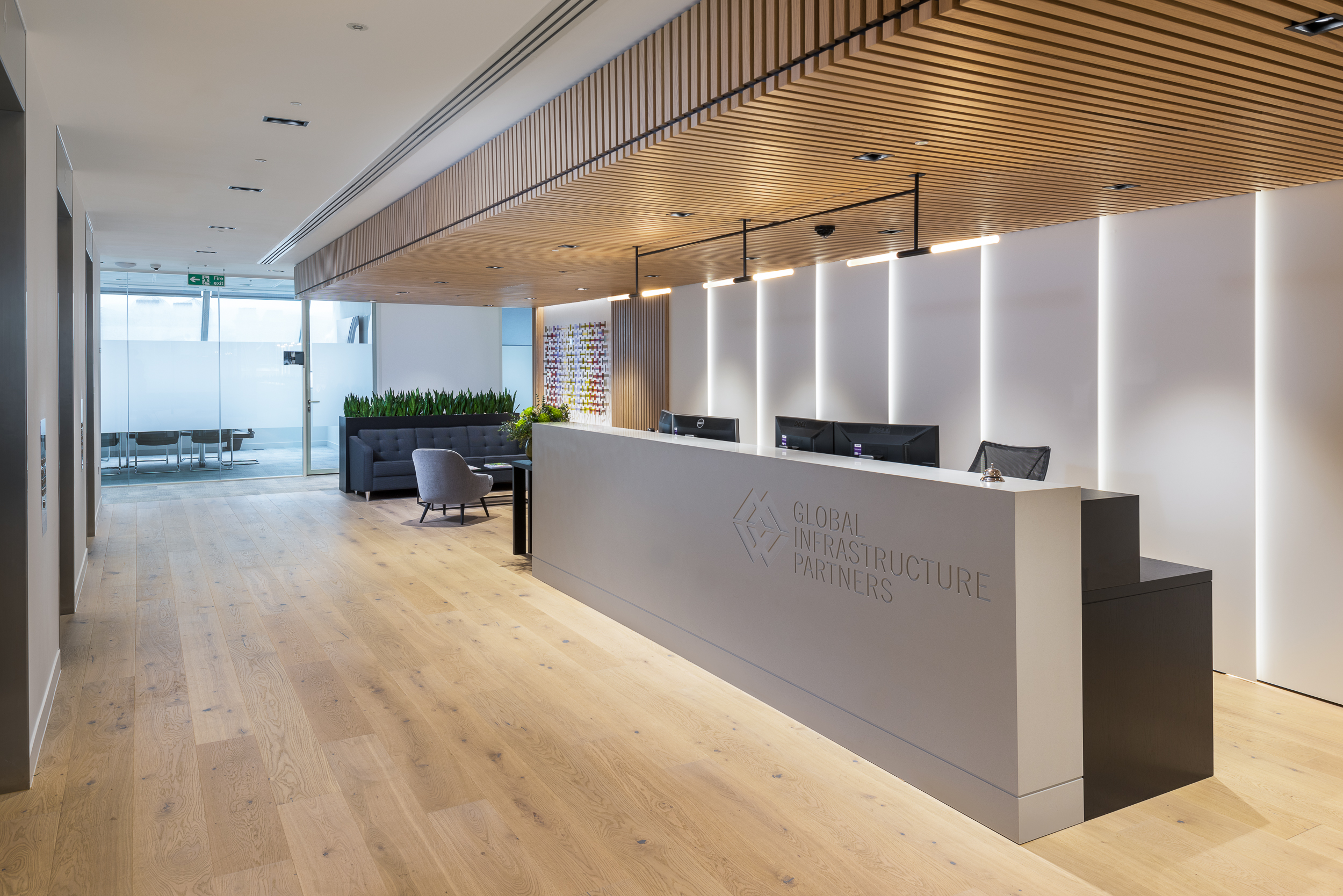GIP's reception area of GIP’s London office, featuring a sleek design with natural wood elements.