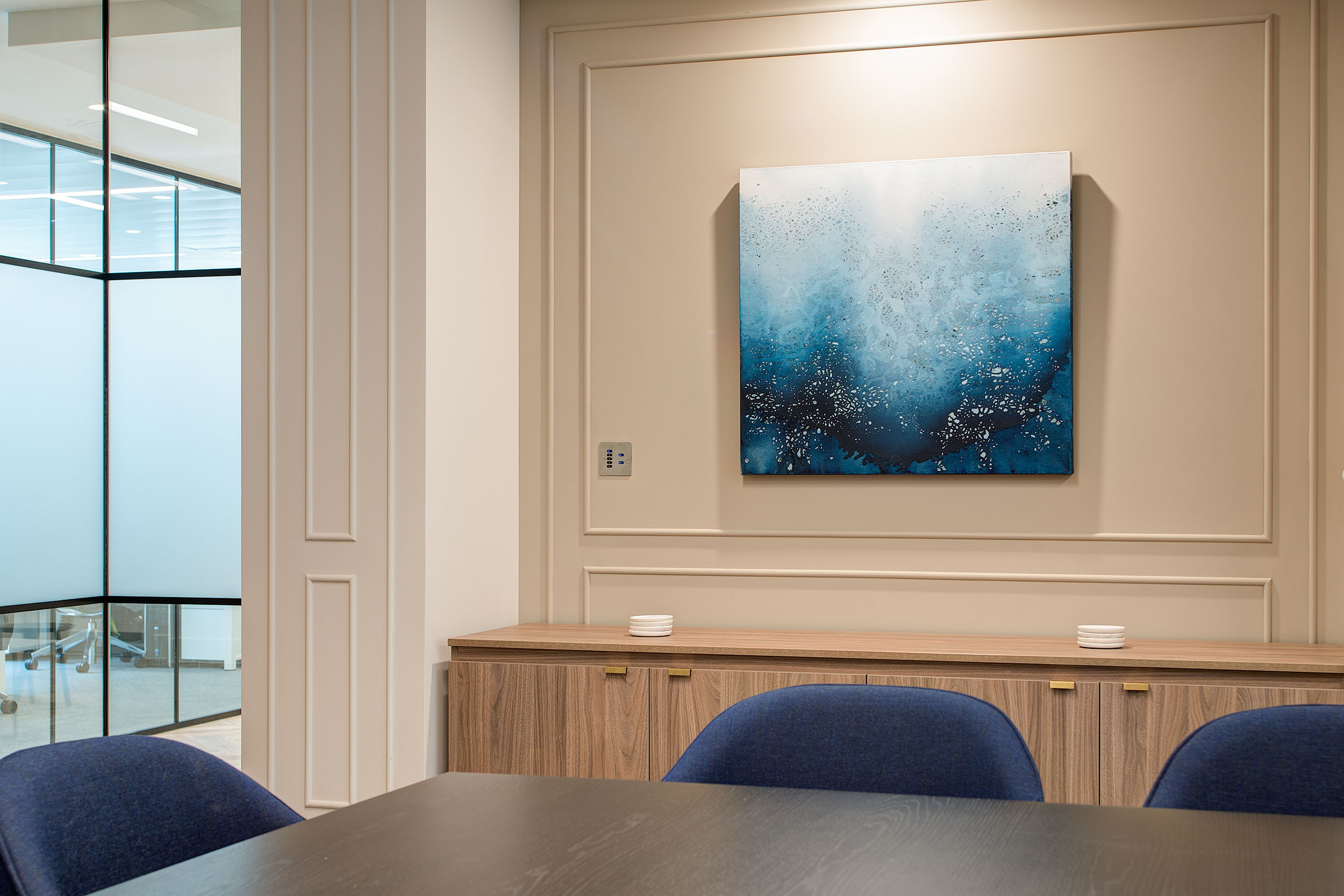 Artistic wall decor in Guinness Asset Management's office, designed by Modus Workspace, adding a touch of elegance and colour to the meeting room setting.