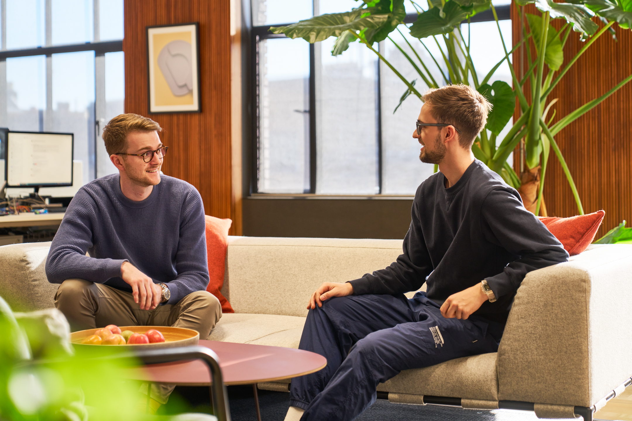 Joseph Joseph employees in a breakout area with natural light and indoor plants.