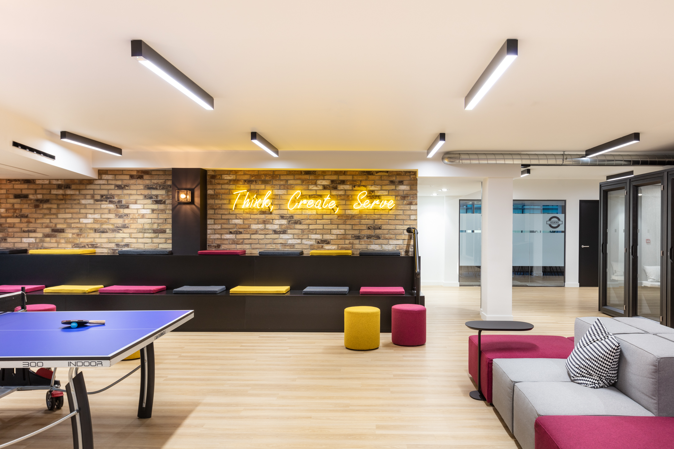 A creative breakout area at Knotel High Holborn featuring colourful seating and a ping pong table. Designed by Modus Workspace to encourage team interaction and relaxation.