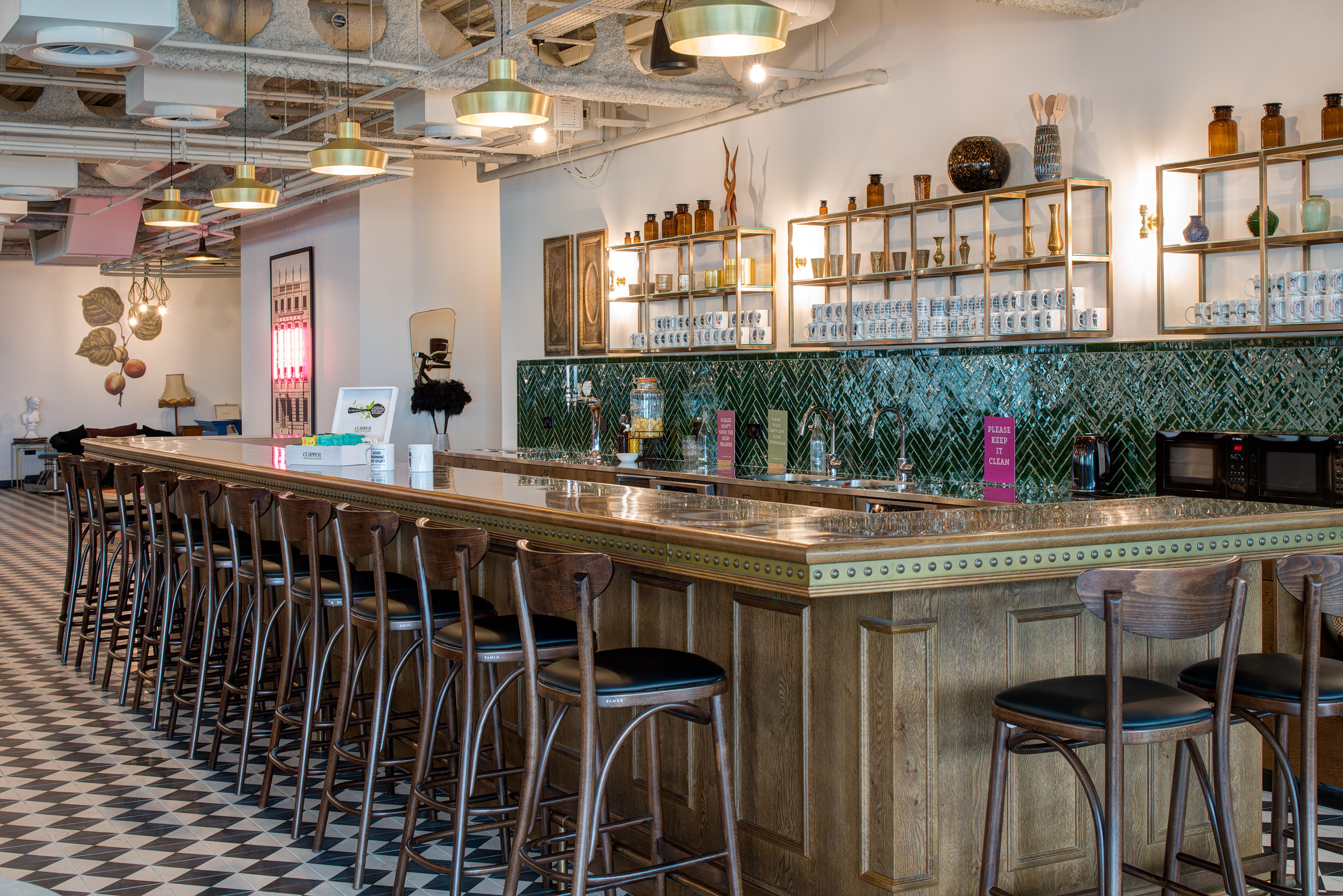 Mindspace Appold Street's teapoint bar area with stools, vintage shelving, and tiled floor, designed by Modus Workspace
