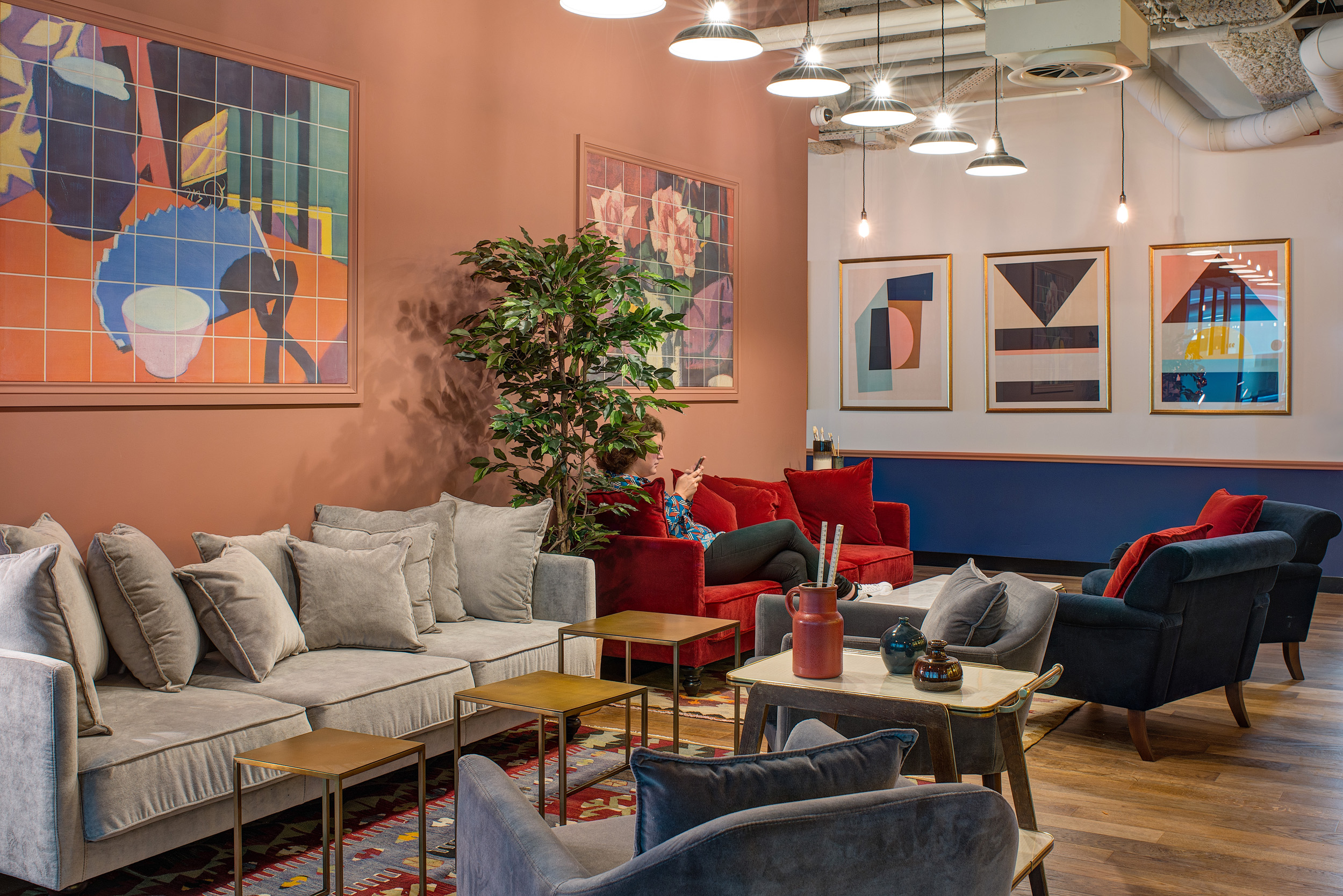 Mindspace Appold Street's lounge space with colourful sofas and framed art on the wall.