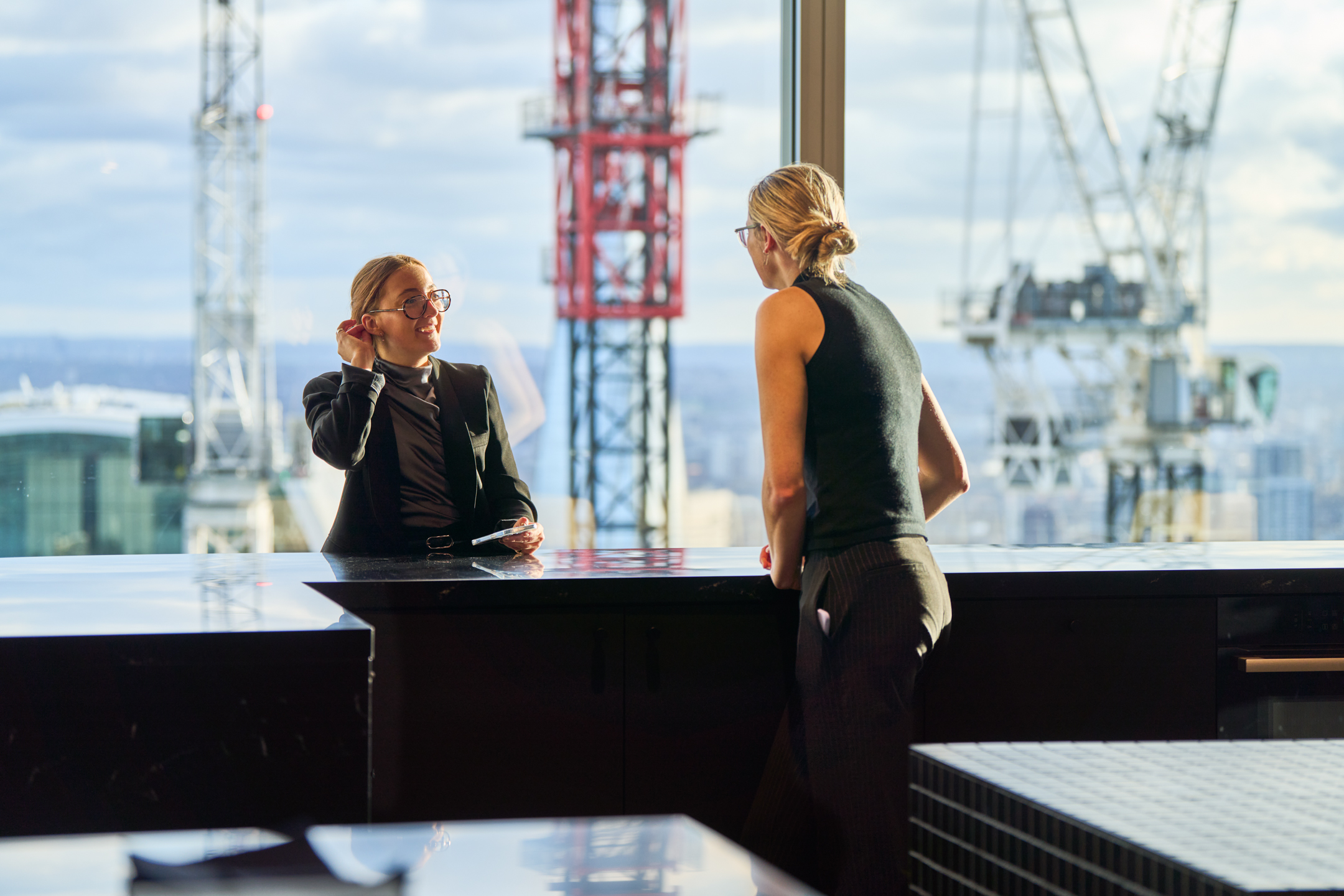 Bentley Systems open plan teapoint with a glass backdrop of the city in the daylight.