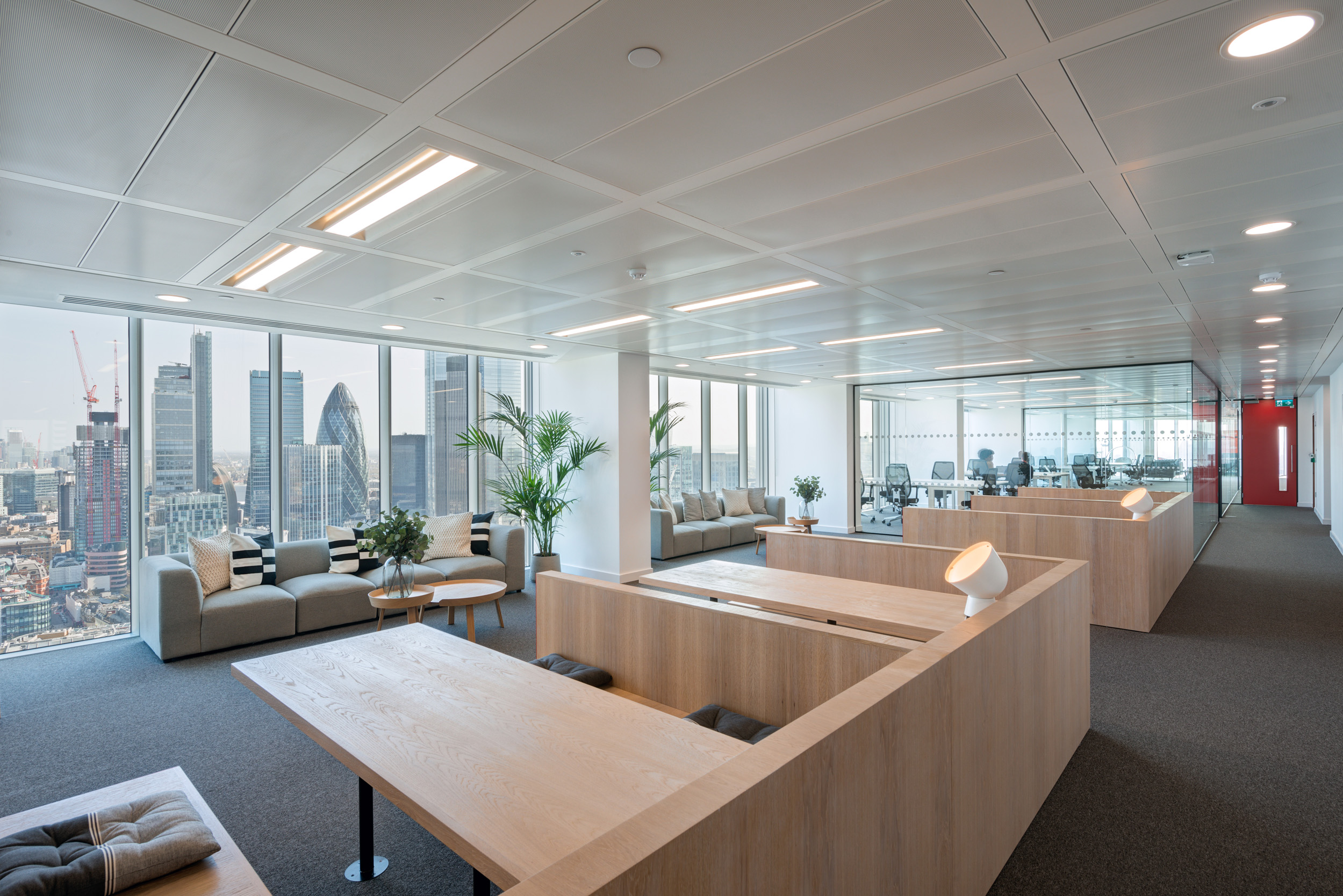 Collaborative space in Primalbase's office designed by Modus Workspace, featuring booth seating and expansive city views for an inspiring work setting.