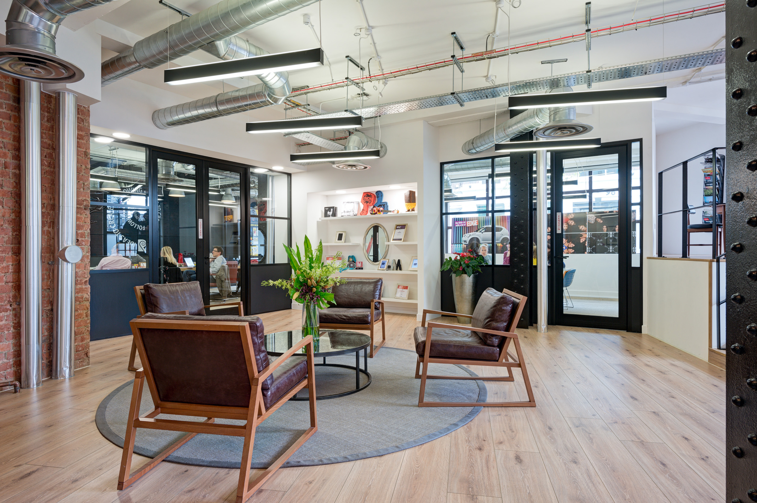 The reception area in the Red Brick Road office doubles as a breakout area for staff, with leather chairs and industrial décor.