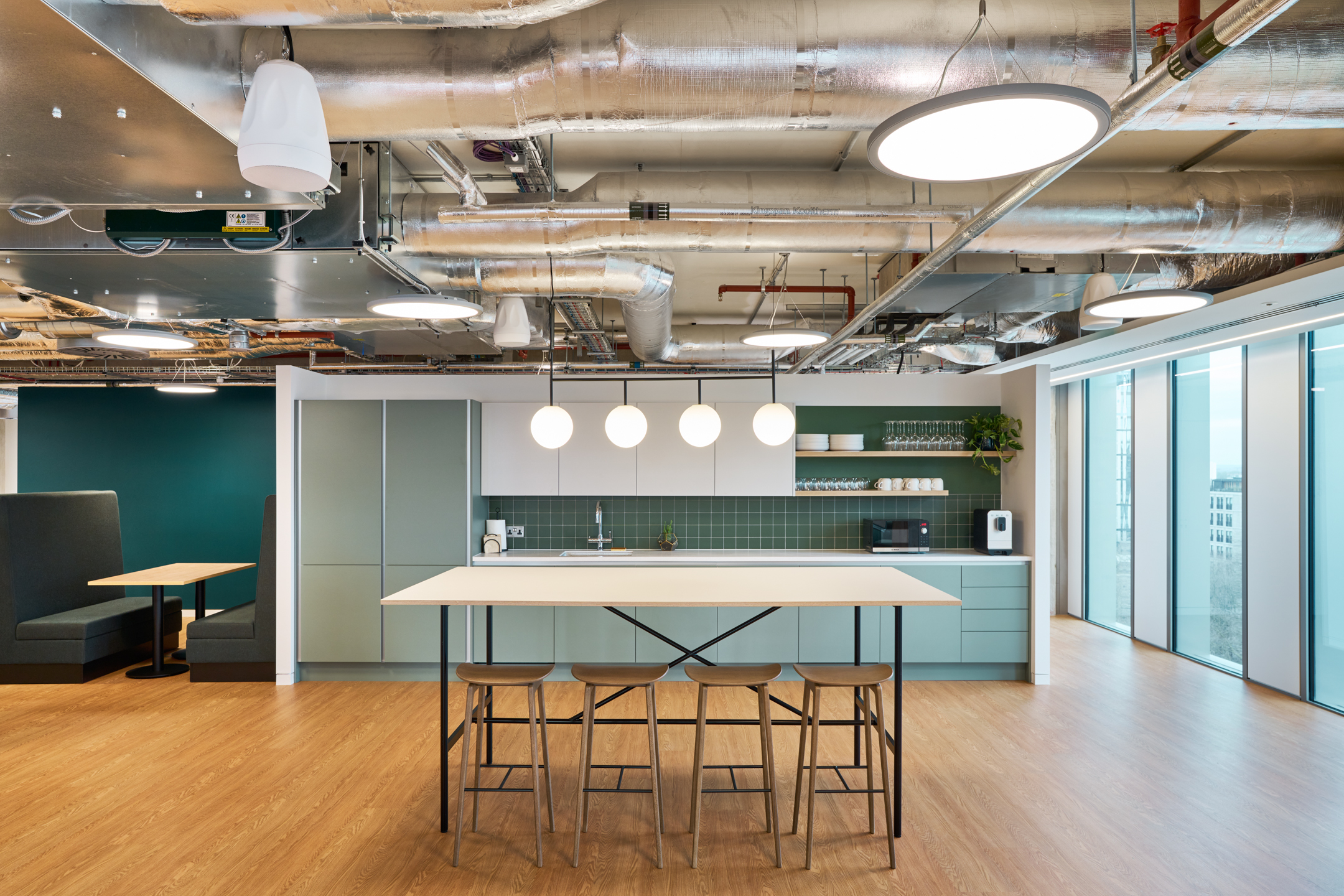 Salesloft’s London office teapoint, with clean lines, modern fixtures, and subtle use of their brand colours to create a functional and aesthetically pleasing space.
