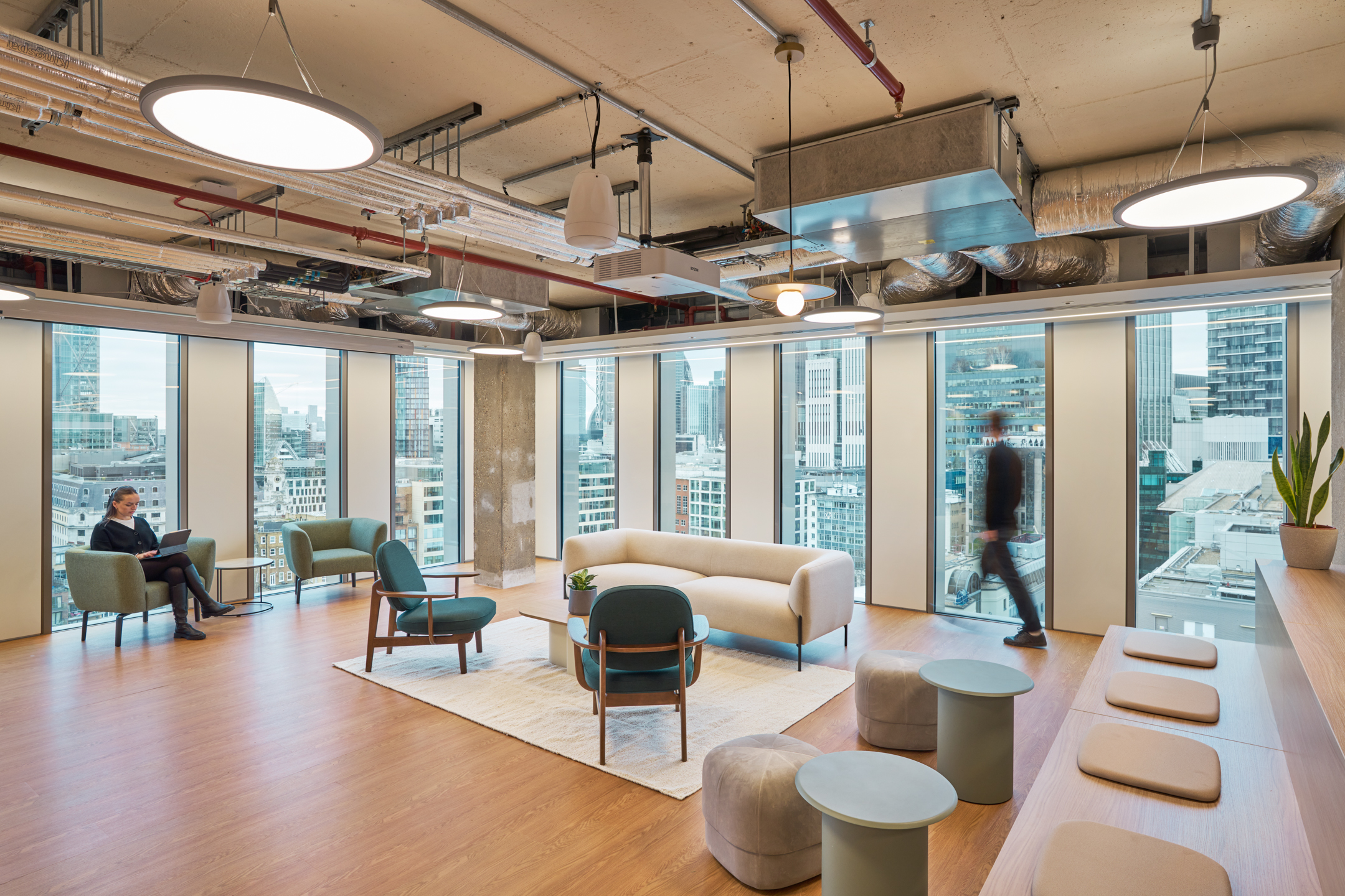 A spacious, light-filled breakout area in Salesloft’s London office, offering a panoramic view of the city, designed to inspire creativity and collaboration.