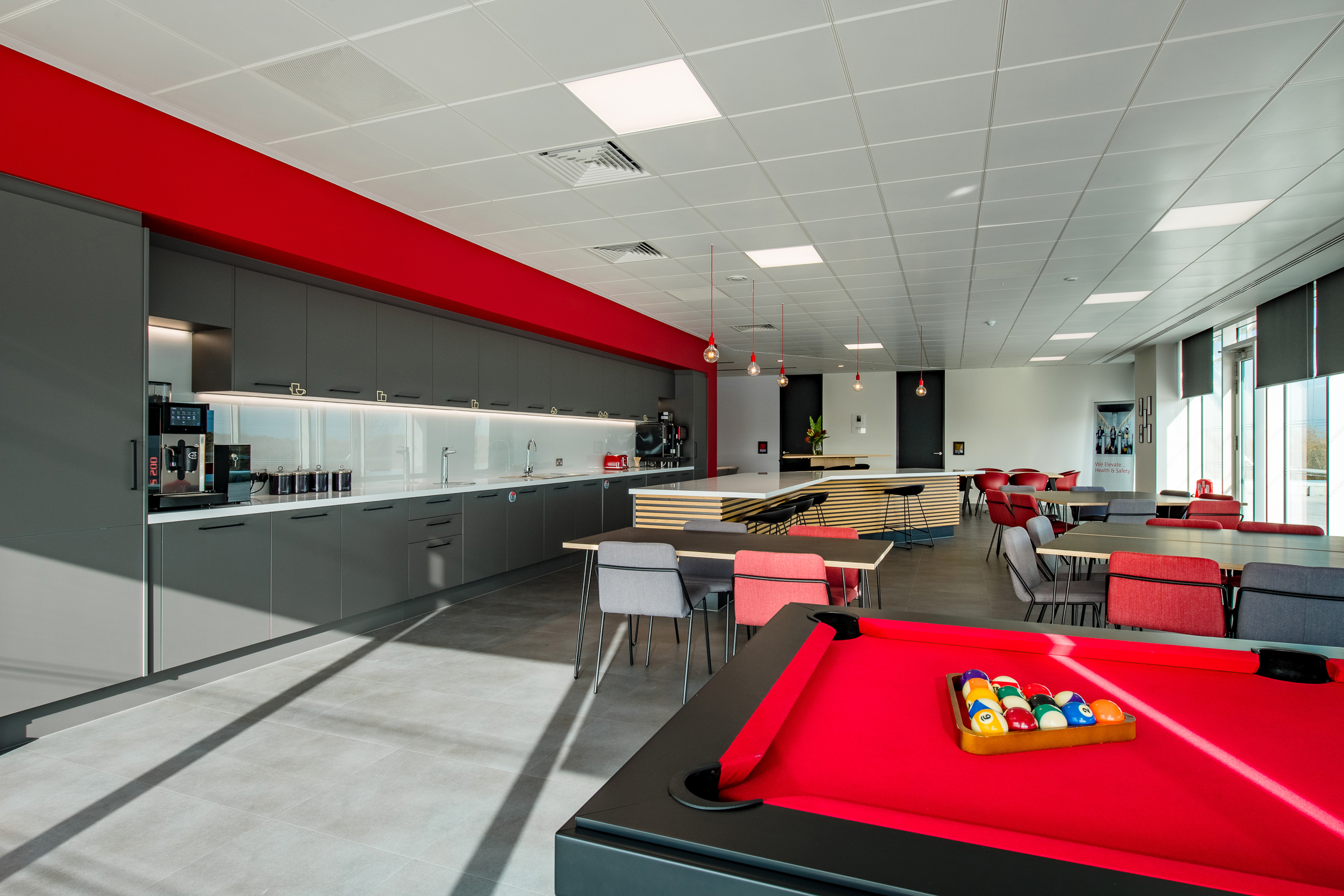 Teapoint area at Schindler Group's UK office, equipped with a central island and breakout seating for informal meetings and social gatherings