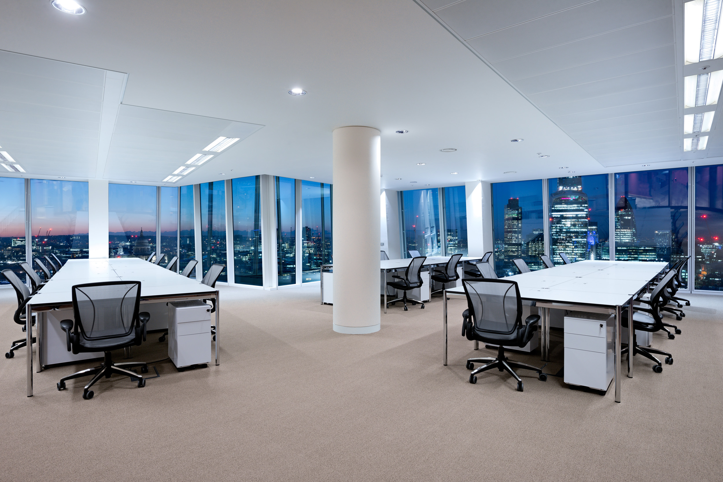 Open-plan desking with stunning views of London’s skyline at sunset from The Office Group’s workspace at The Shard.