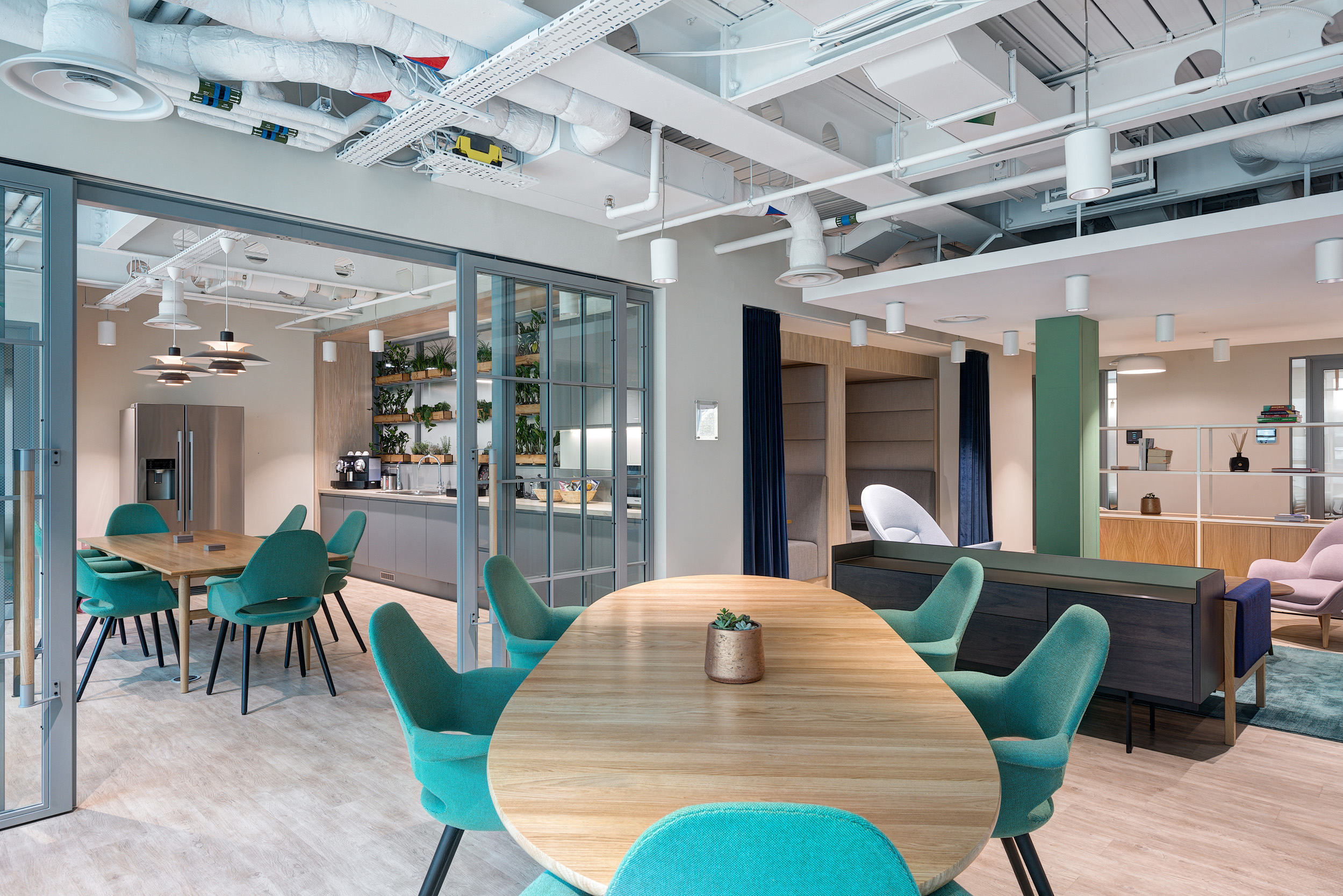 Vitruvian Partners’ teapoint at Marylebone office features contemporary furniture and integrated plant shelving, designed to promote collaboration and employee well-being.
