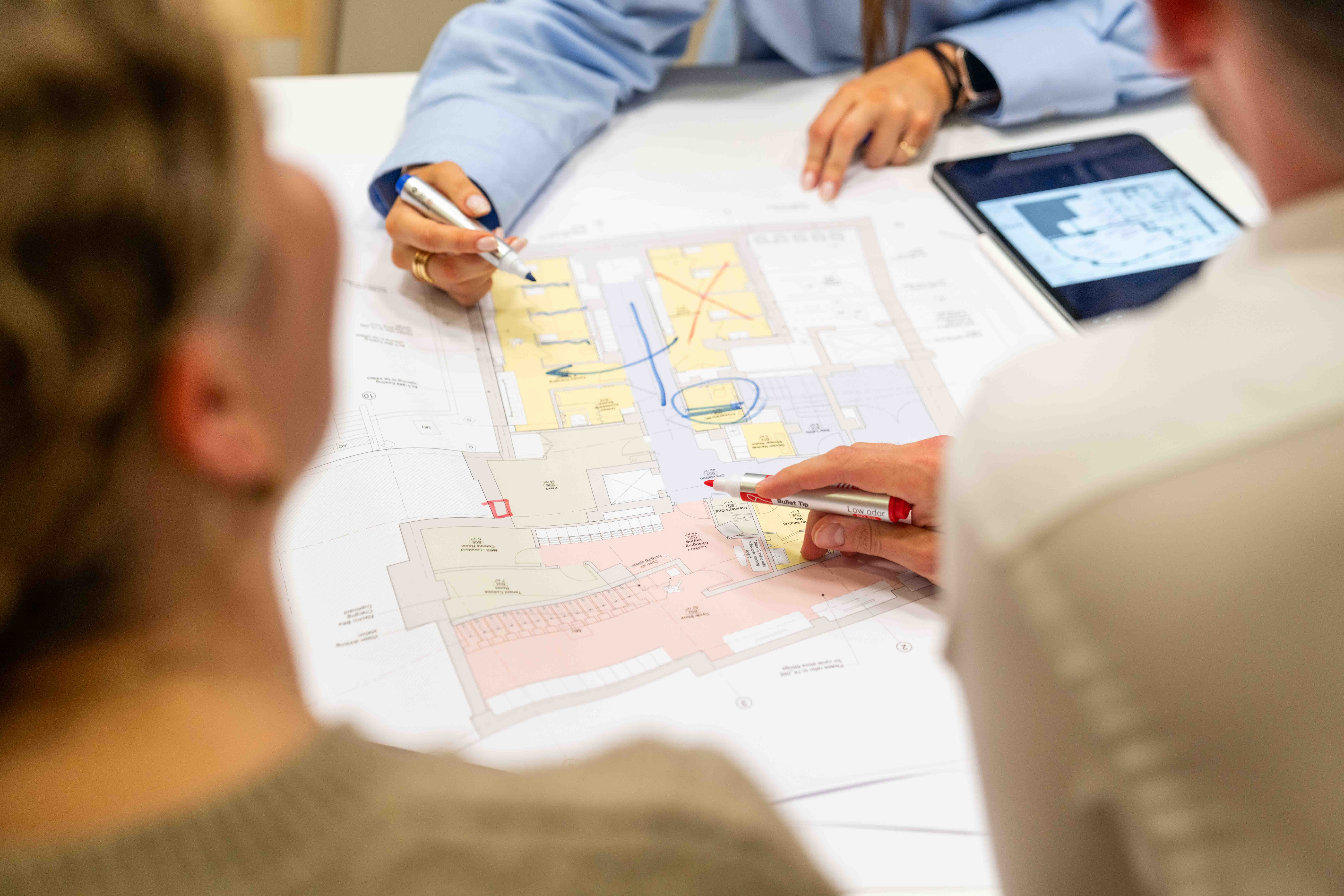 Modus team collaborating on the office design plan for The Watches of Switzerland, focusing on detailed planning and innovative workspace solutions.
