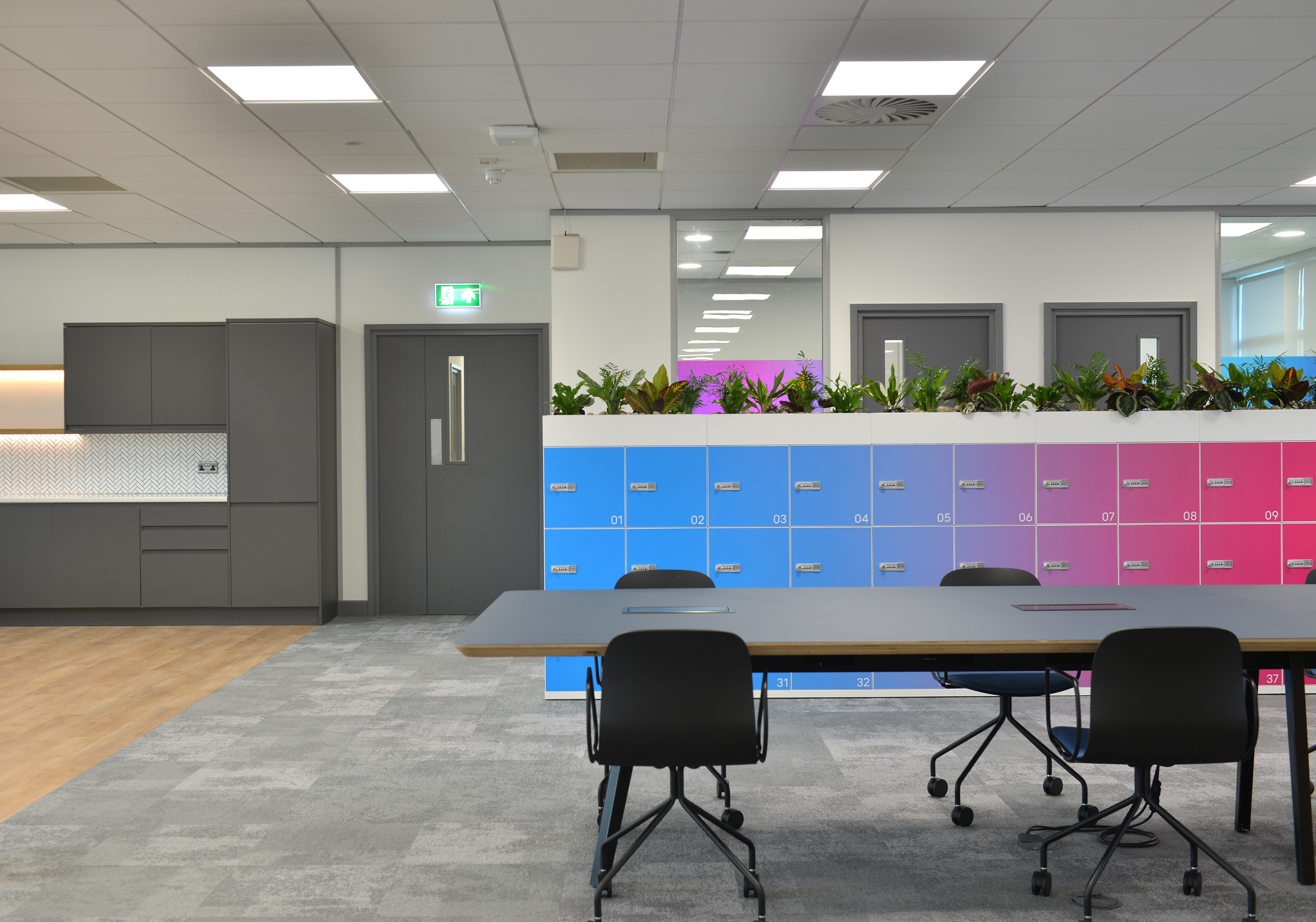 Warrington Colourful lockers at Fujitsu Services Warrington office, providing secure storage for employees. Designed by Modus Workspace, the gradient effect adds a dynamic touch to the workplace.