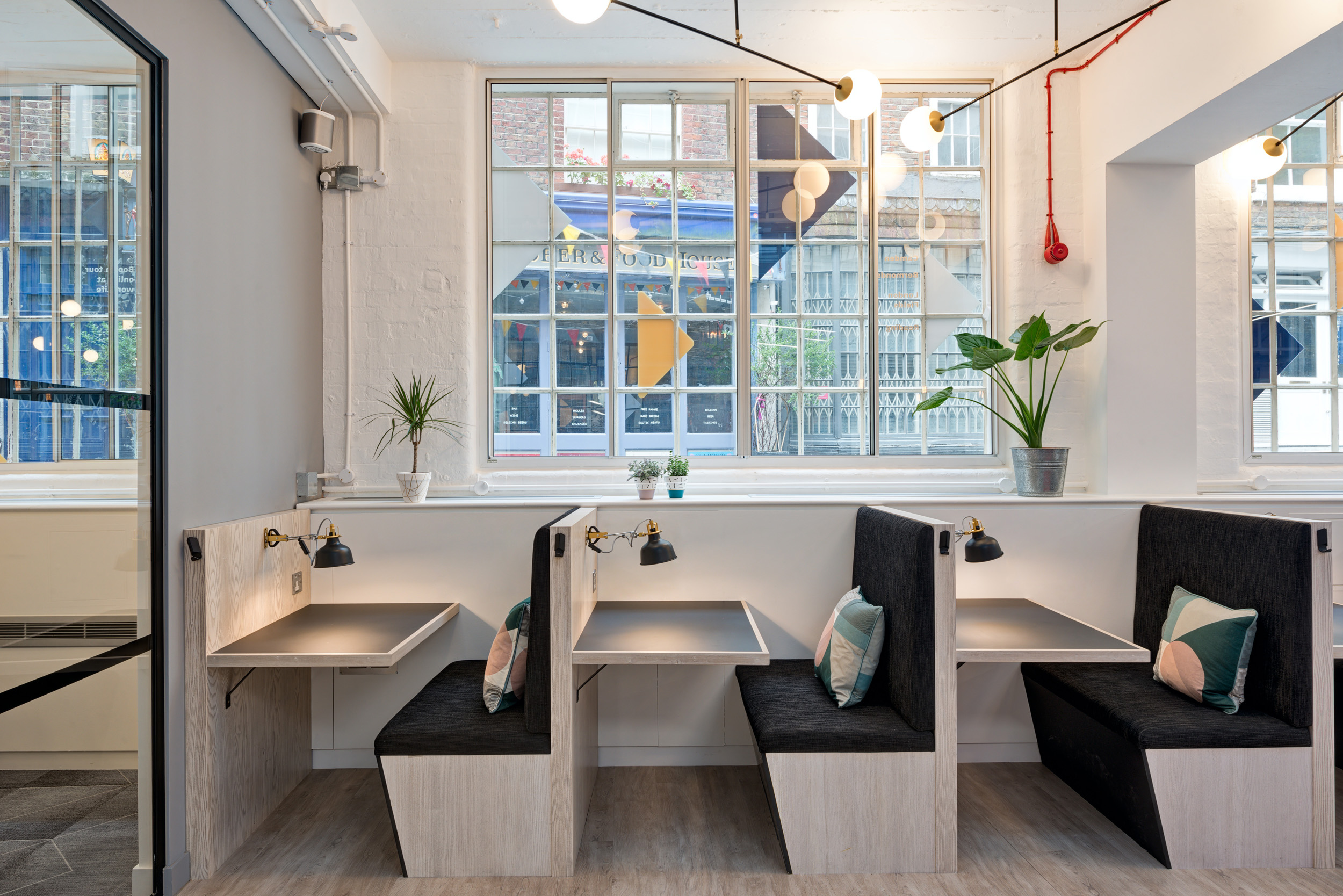 Worklife Clerkenwell private booths designed by Modus Workspace with ample natural light, and a view of the bustling street outside, creating a perfect environment for productivity.