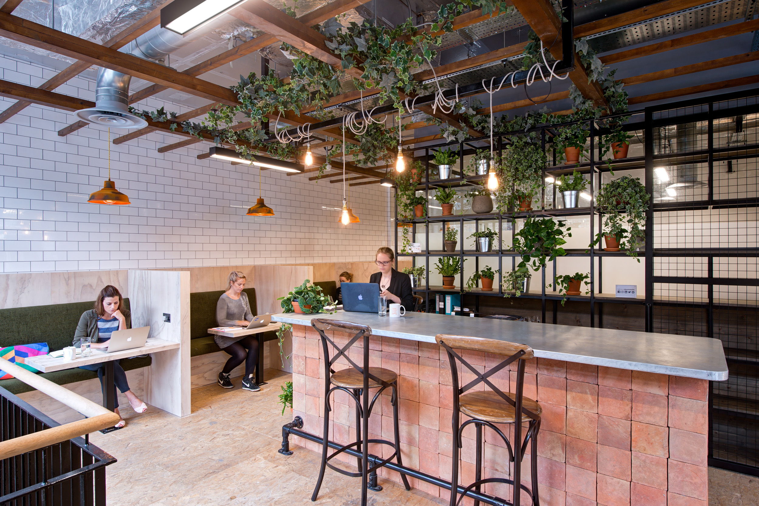 Worklife London Fields Reception area, designed by Modus Workspace, showcasing a blend of open workstations and natural greenery for a welcoming and productive office atmosphere.