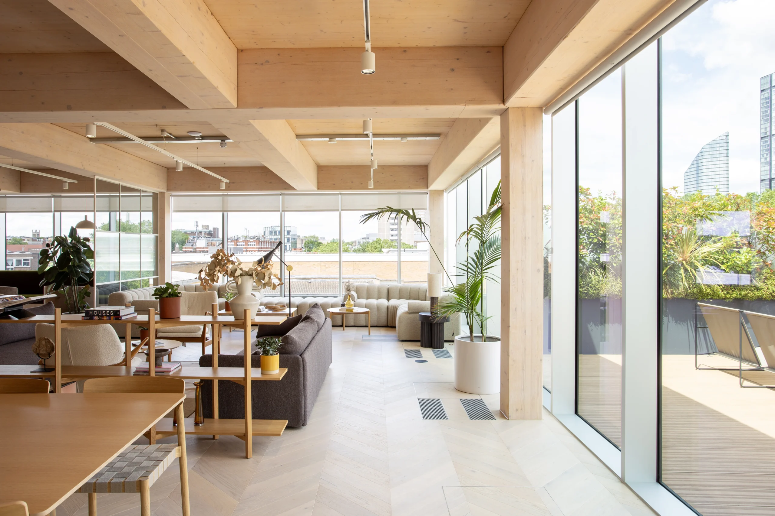 Techspace seating area with a view, featuring cream painted ceiling and pillar, looking outwards to the skyline of London